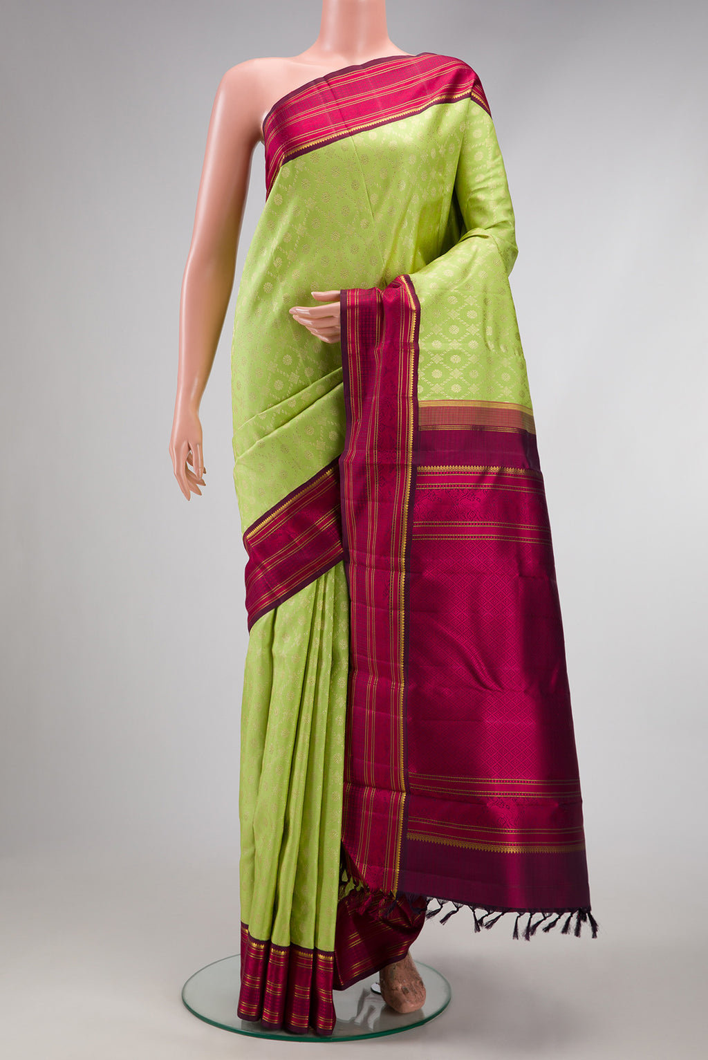 Light Green Dual Tone Kanchipuram Silk Saree with Zari Brocade on the body and Zari And Thread Border.  displayed on a mannequin
