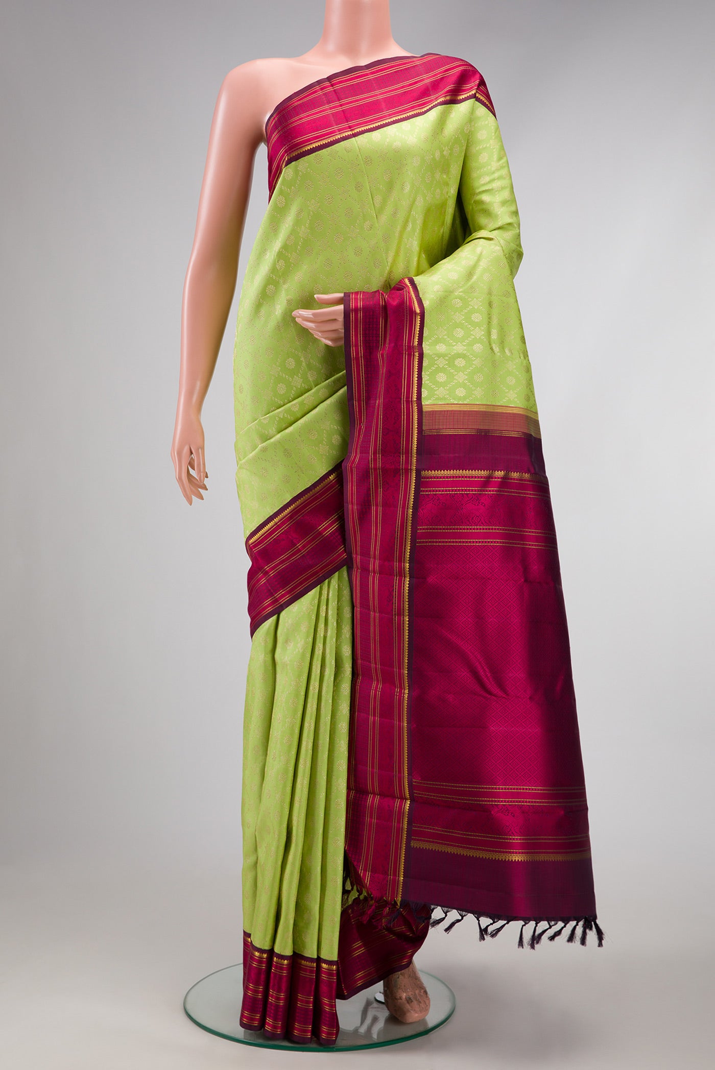 Light Green Dual Tone Kanchipuram Silk Saree with Zari Brocade on the body and Zari And Thread Border.  displayed on a mannequin
