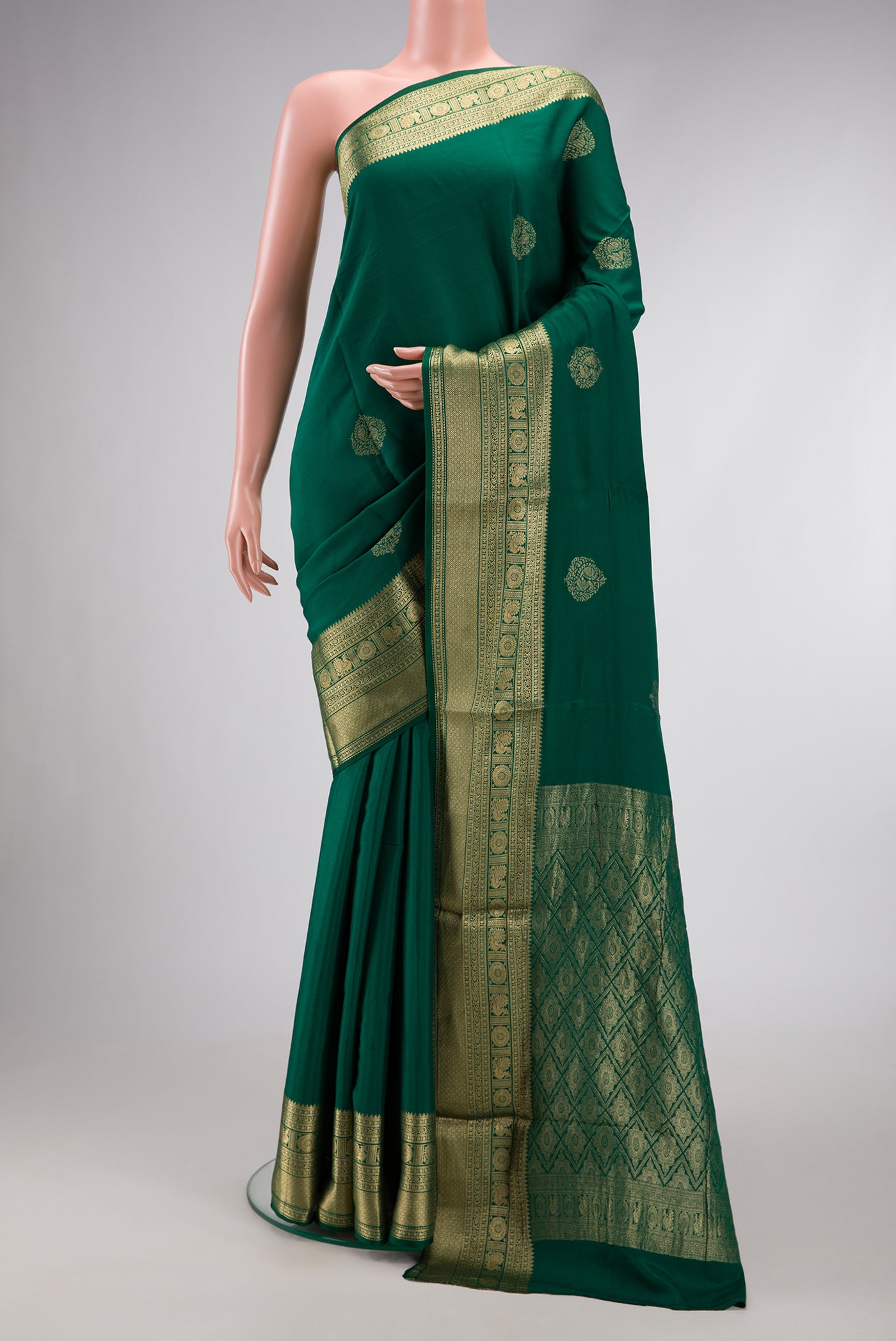 Bottle Green Dual Tone Mysore Georgette Saree with Zari Butta on the body and Zari Border.  displayed on a mannequin