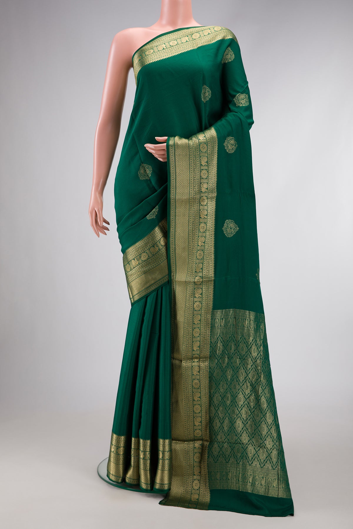 Bottle Green Dual Tone Mysore Georgette Saree with Zari Butta on the body and Zari Border.  displayed on a mannequin