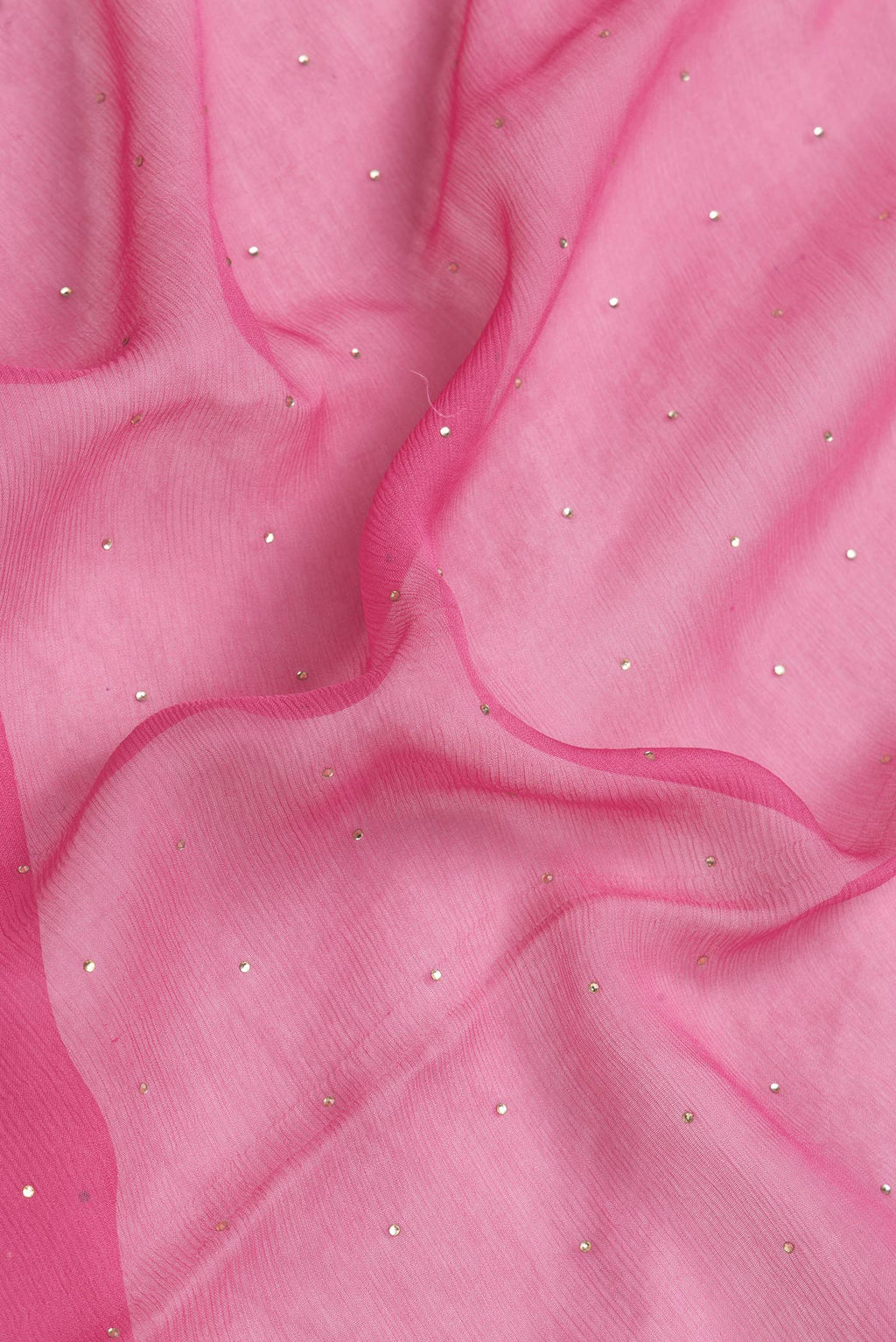 Close up of Pink Dual Tone Chiffon Saree with Embroidery on the body and Zari Border.  displaying folds