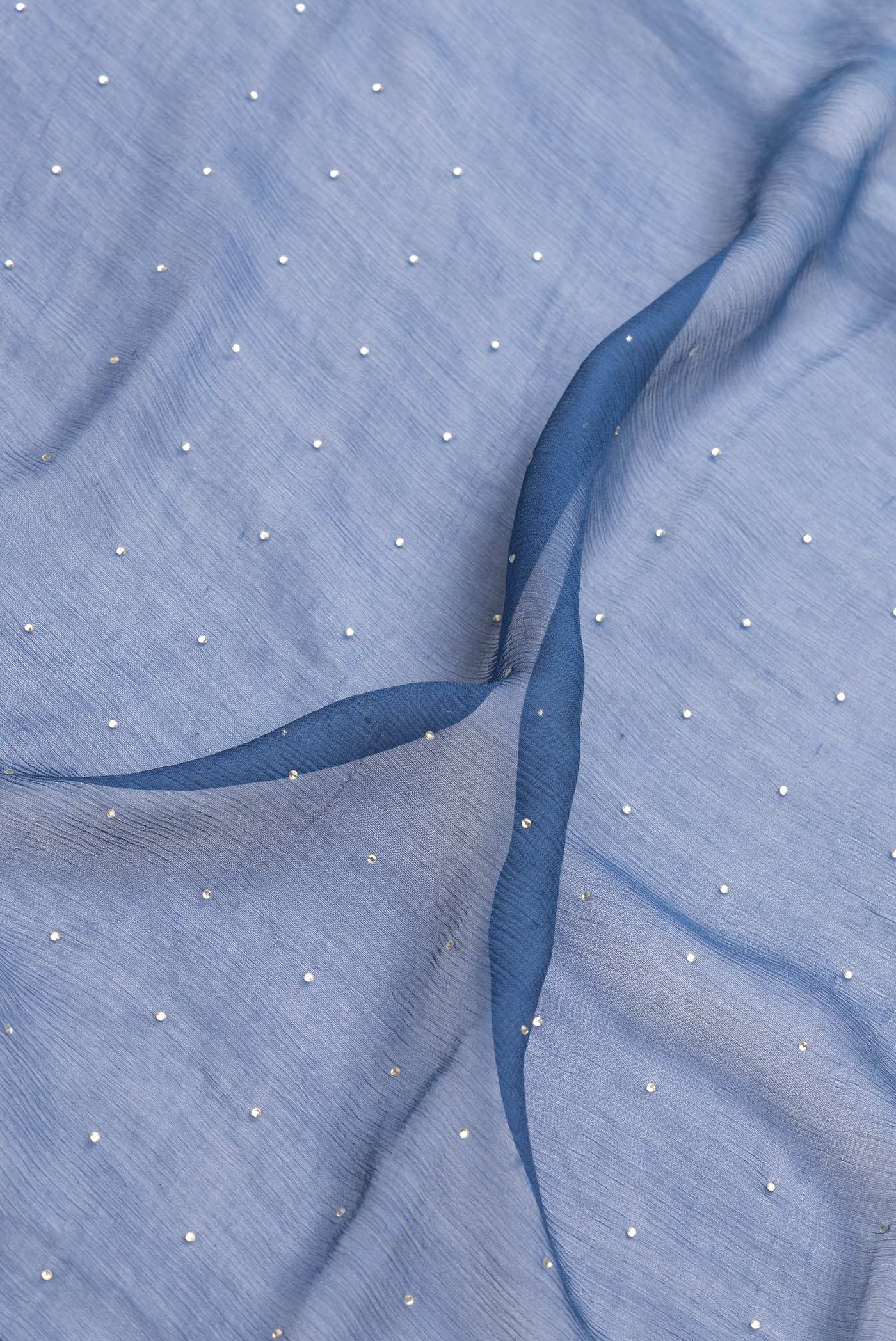 Close up of Maya Blue Dual Tone Mysore Georgette Saree with Embroidery on the body and Zari Border.  displaying folds
