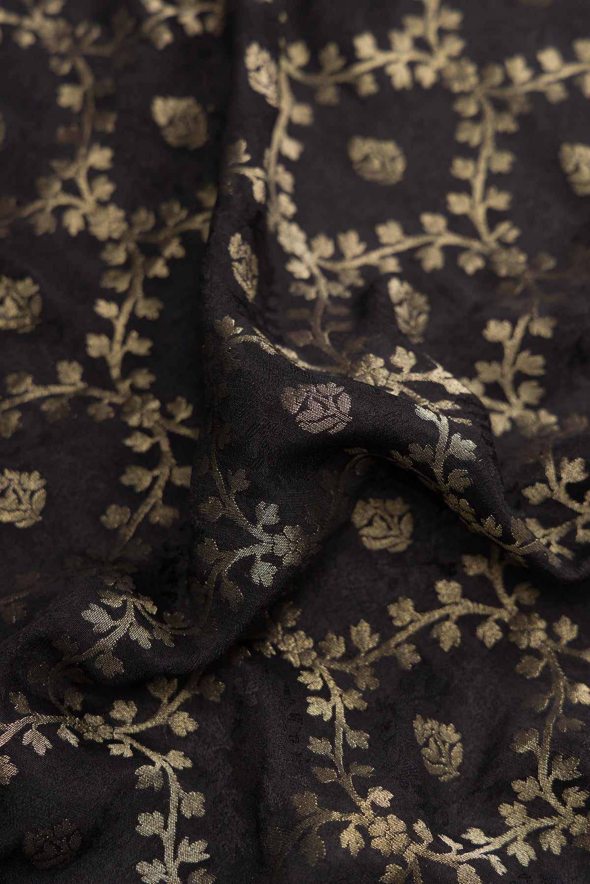 Close up of Black Dual Tone Mysore Georgette Saree with Zari Brocade on the body and Zari Border.  displaying folds