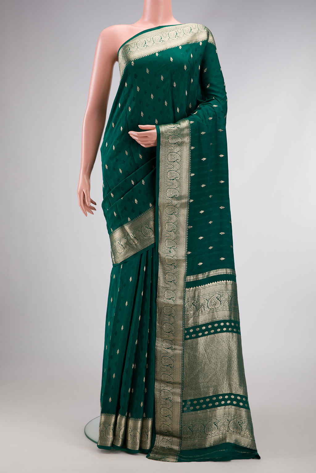 Bottle Green Dual Tone Mysore Georgette Saree with Zari Butta on the body and Zari Border.  displayed on a mannequin