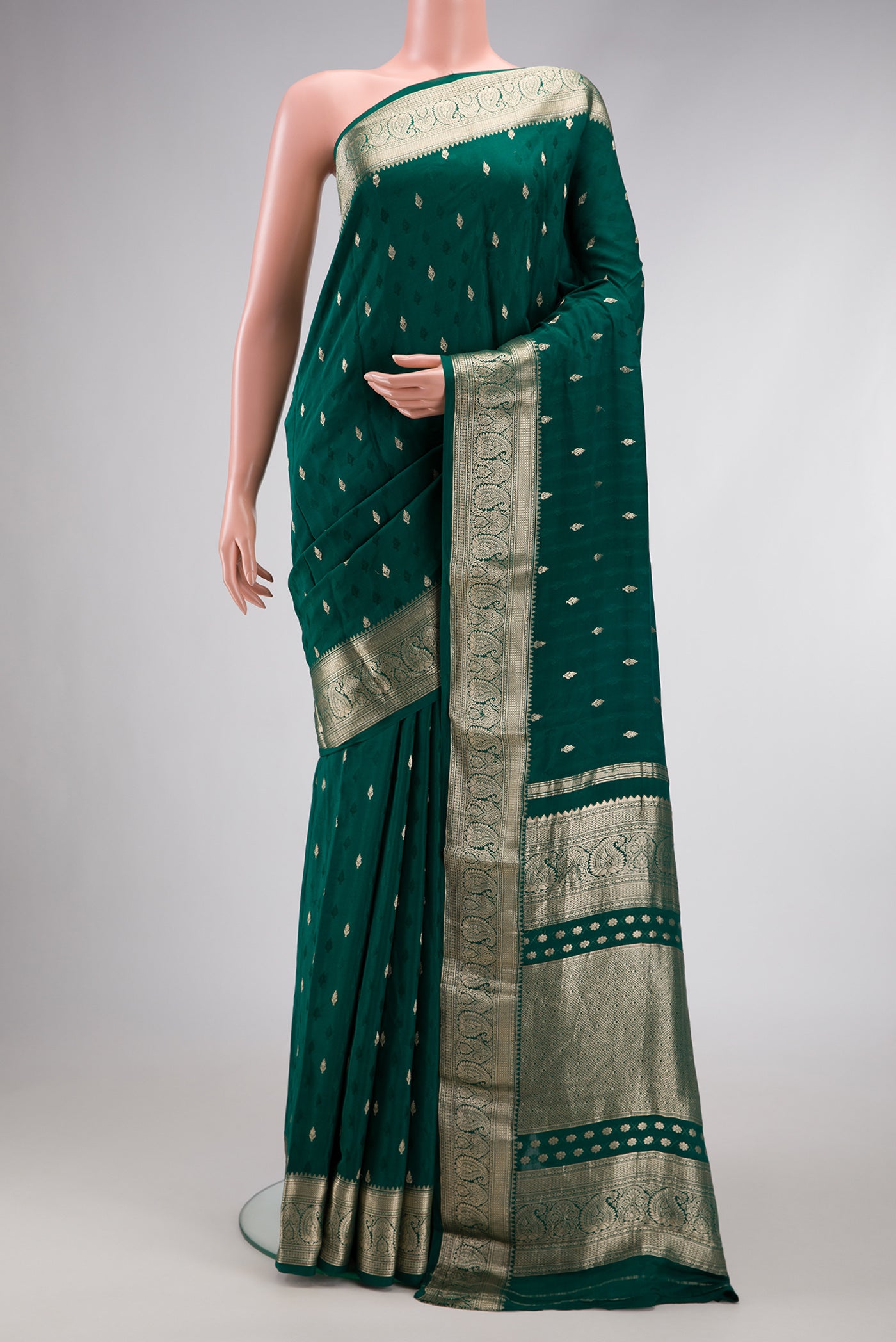 Bottle Green Dual Tone Mysore Georgette Saree with Zari Butta on the body and Zari Border.  displayed on a mannequin