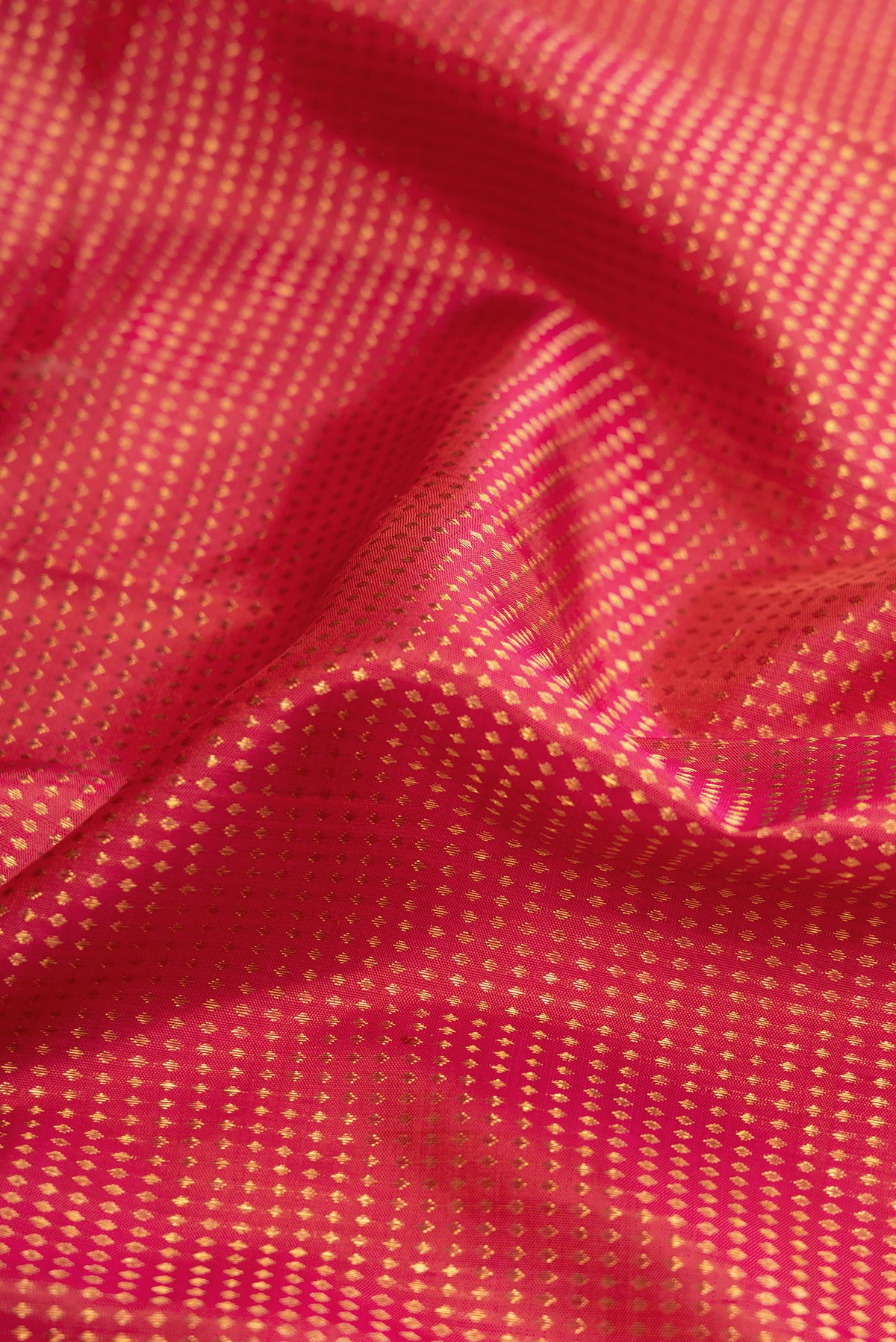 Close up of Dark Pink Dual Tone Kanjivaram Silk Saree with Stripes on the body and Zari Border.  displaying folds