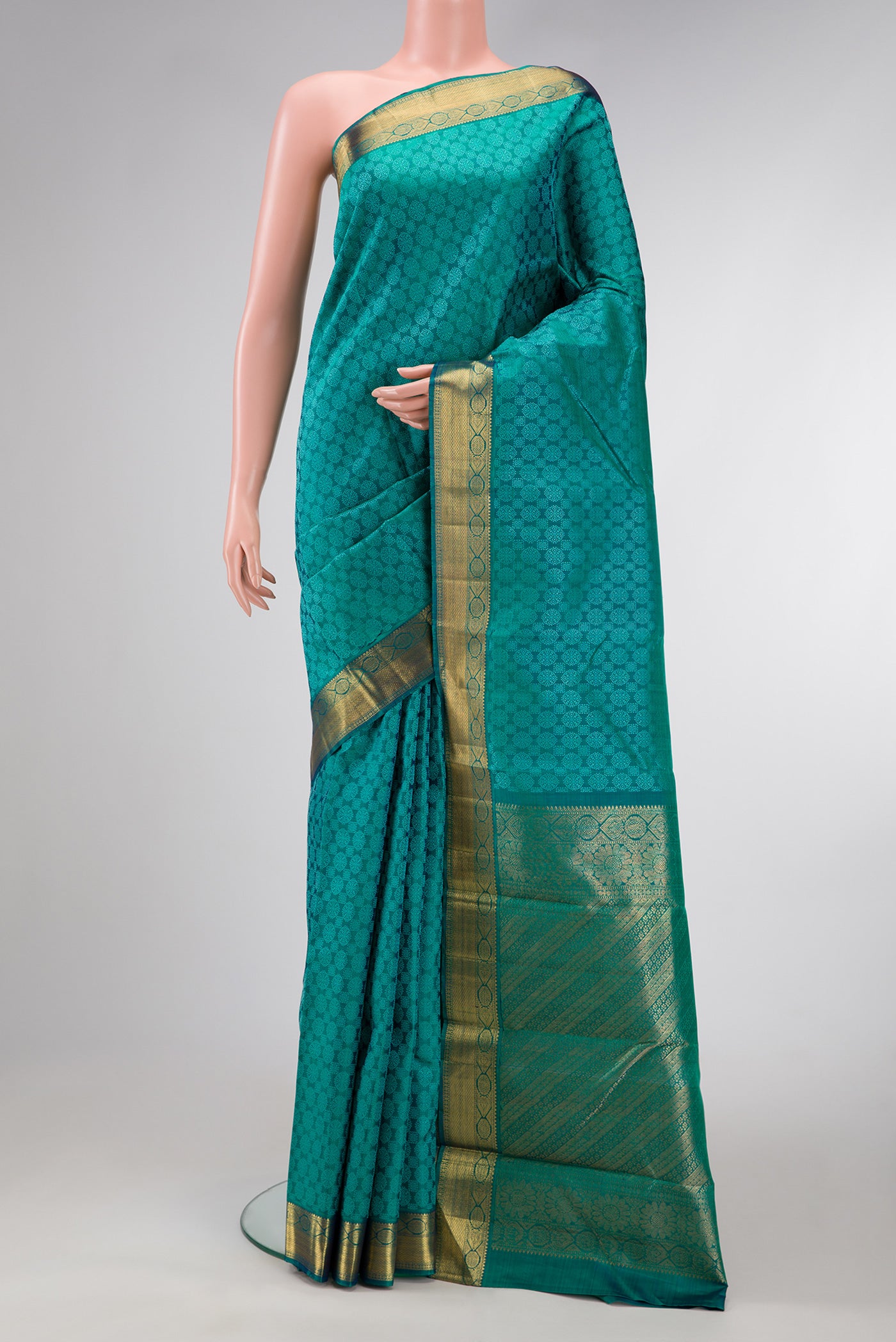 Peacock Blue Dual Tone Kanjivaram Silk Saree with Jacquard design on the body and Zari Border.  displayed on a mannequin