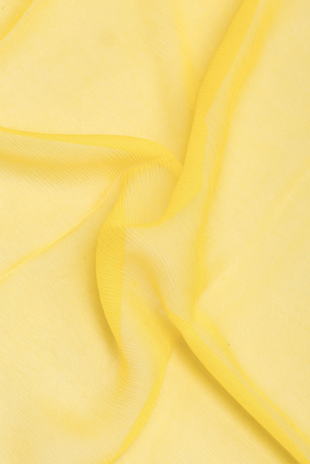 Close up of Lemon Yellow Mysore Chiffon Saree with Plain Body and Zari Border.  displaying folds