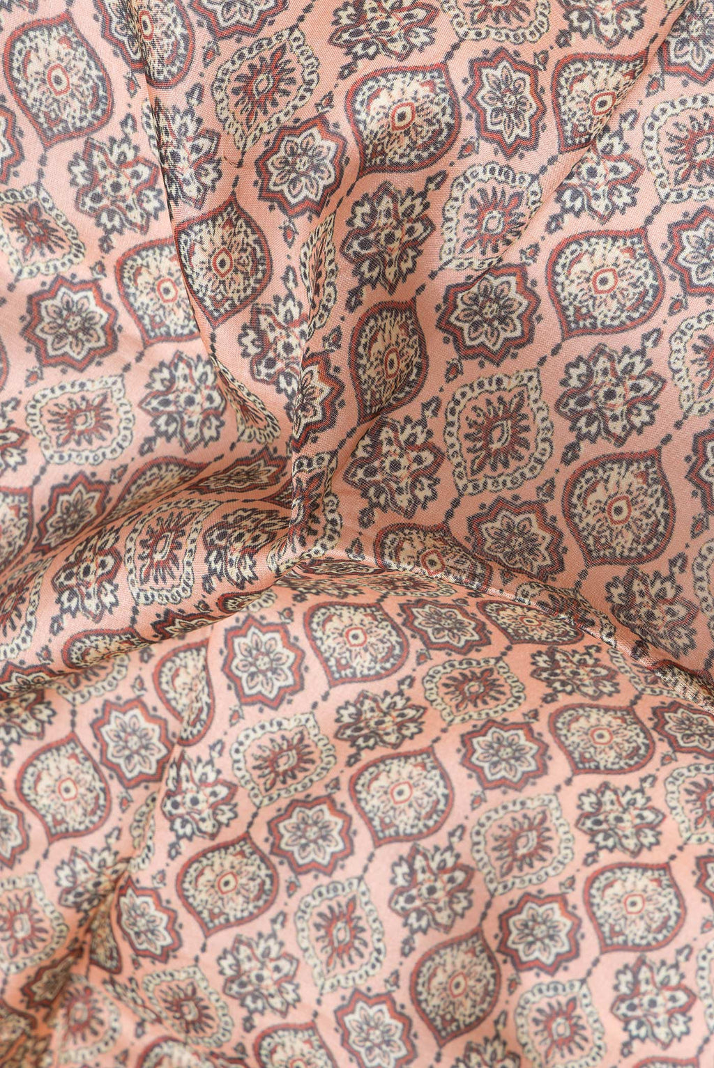Close up of Golden Peach Dual Tone Tussar Silk Saree with Printed design on the body and Zari Border.  displaying folds