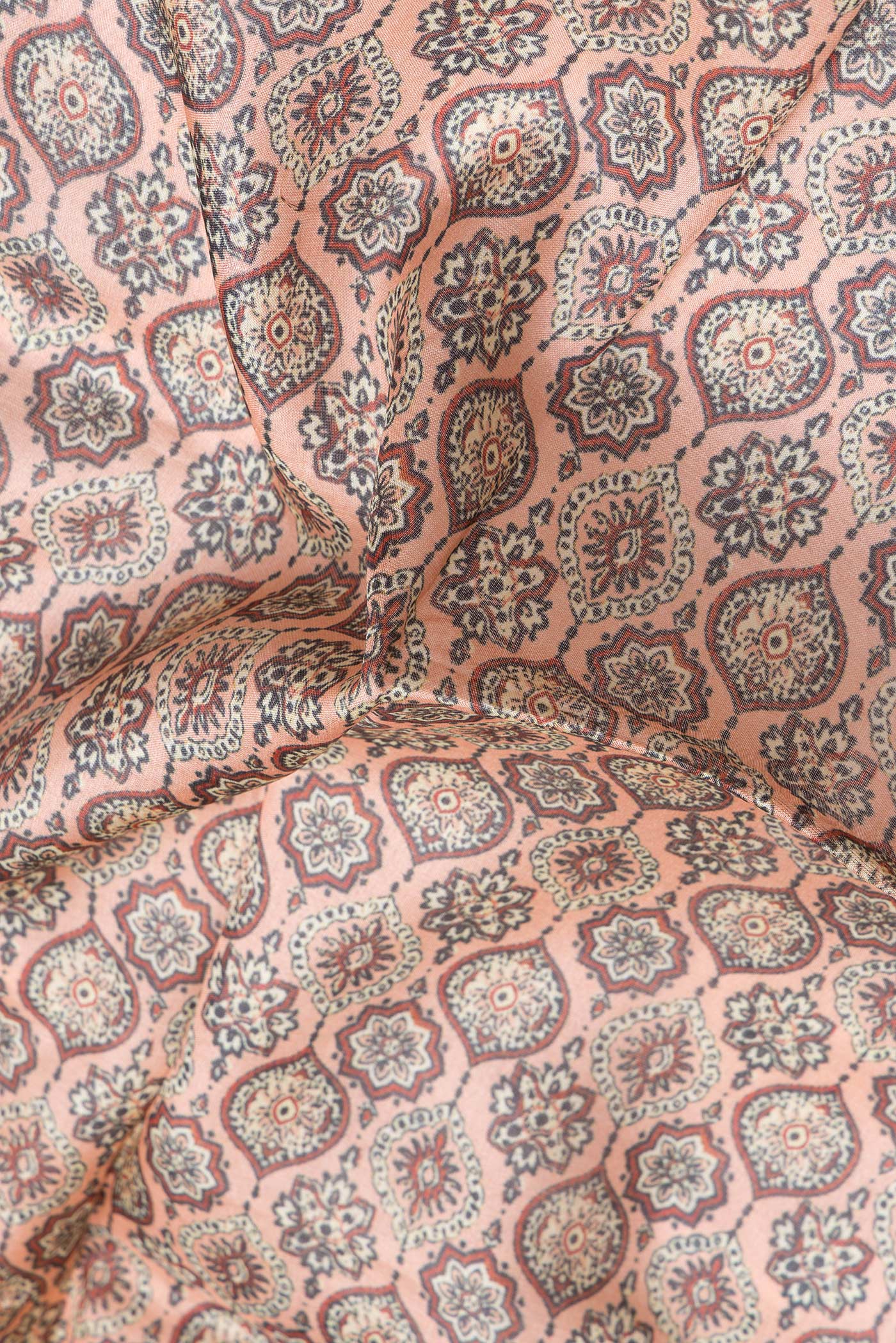 Close up of Golden Peach Dual Tone Tussar Silk Saree with Printed design on the body and Zari Border.  displaying folds