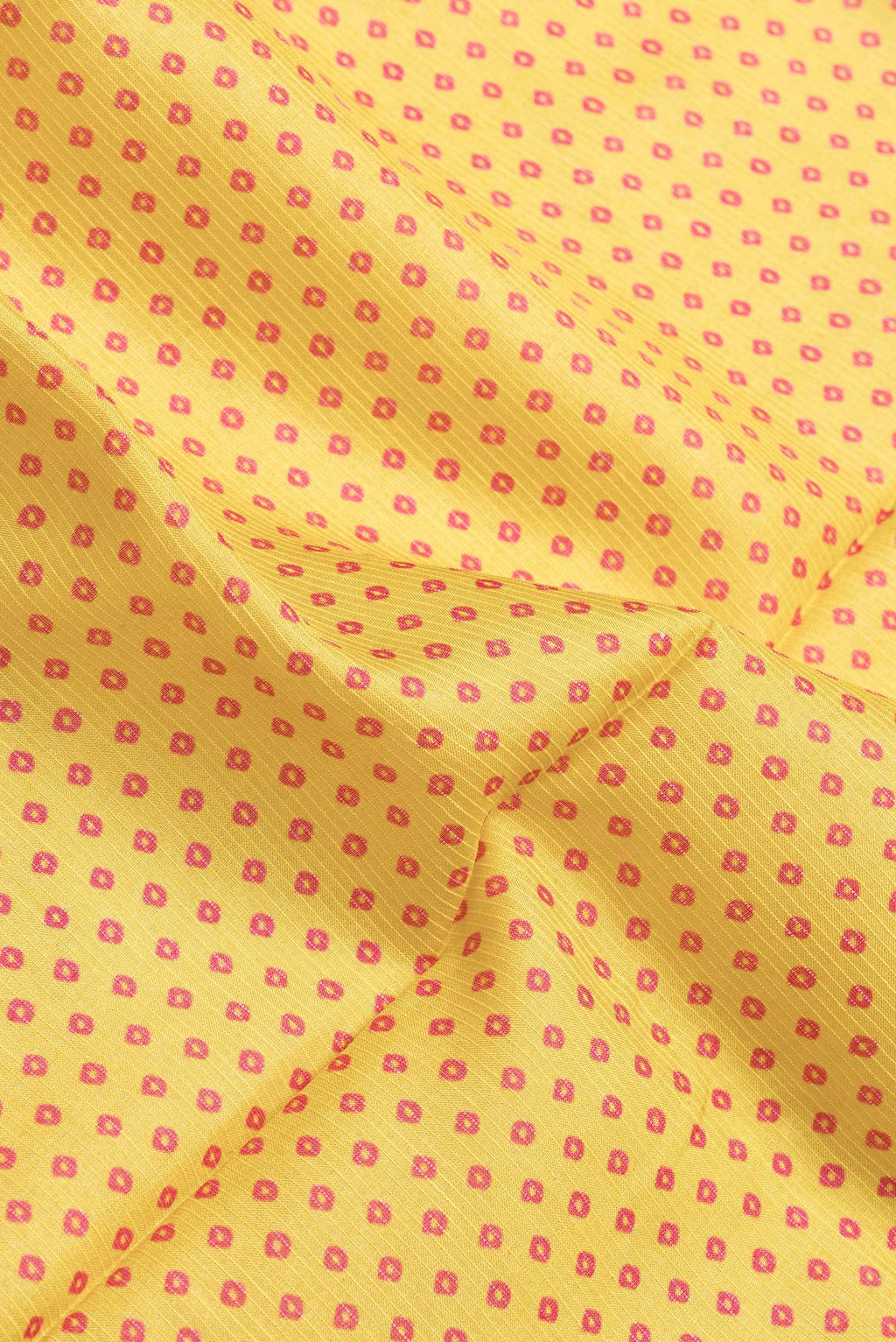 Close up of Yellow Dual Tone Tussar Silk Saree with Bandhani Print on the body and Zari Border.  displaying folds