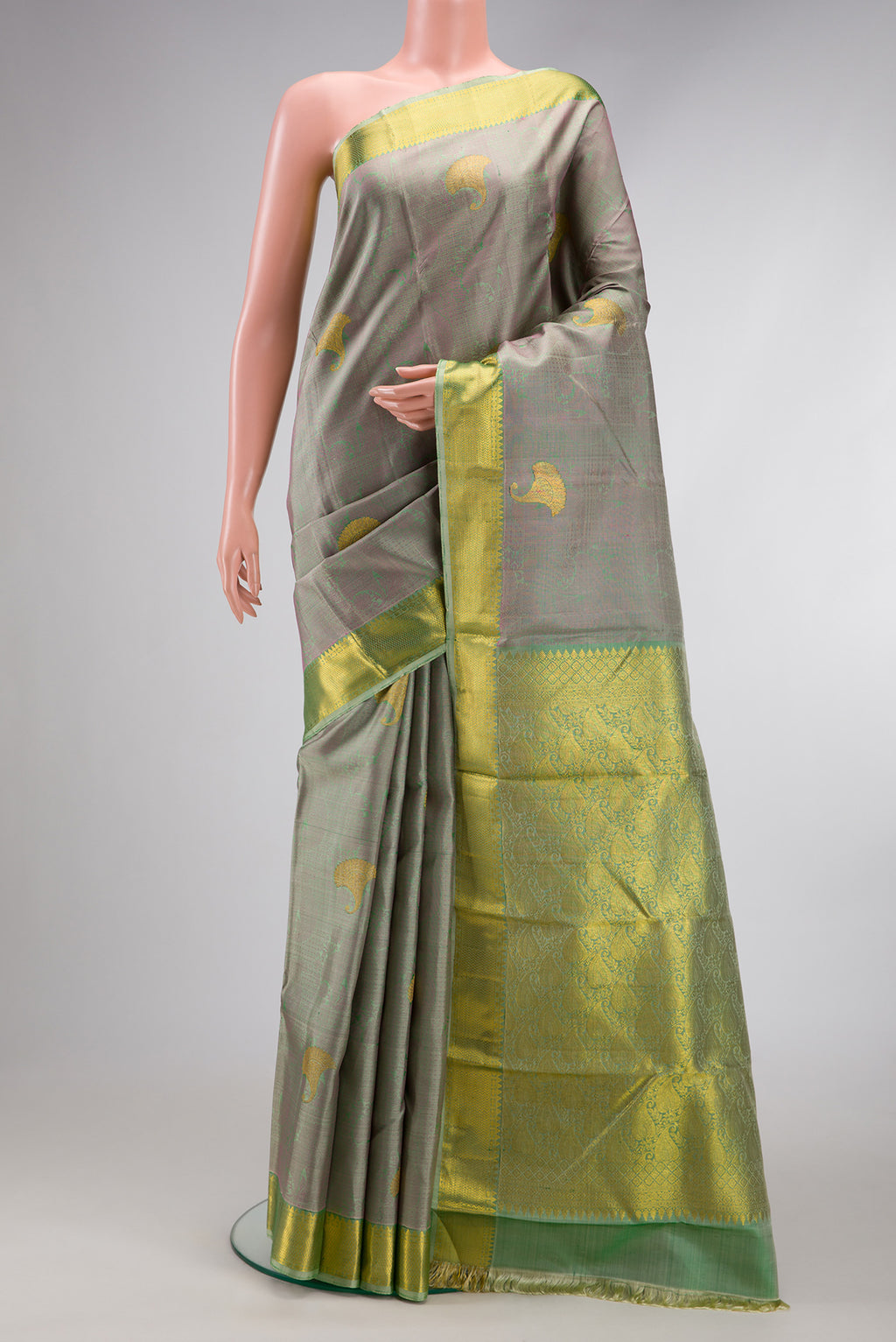 Pista Green Dual Tone Kanjivaram Silk Saree with Jacquard With Zari Butta on the body and Zari Border.  displayed on a mannequin