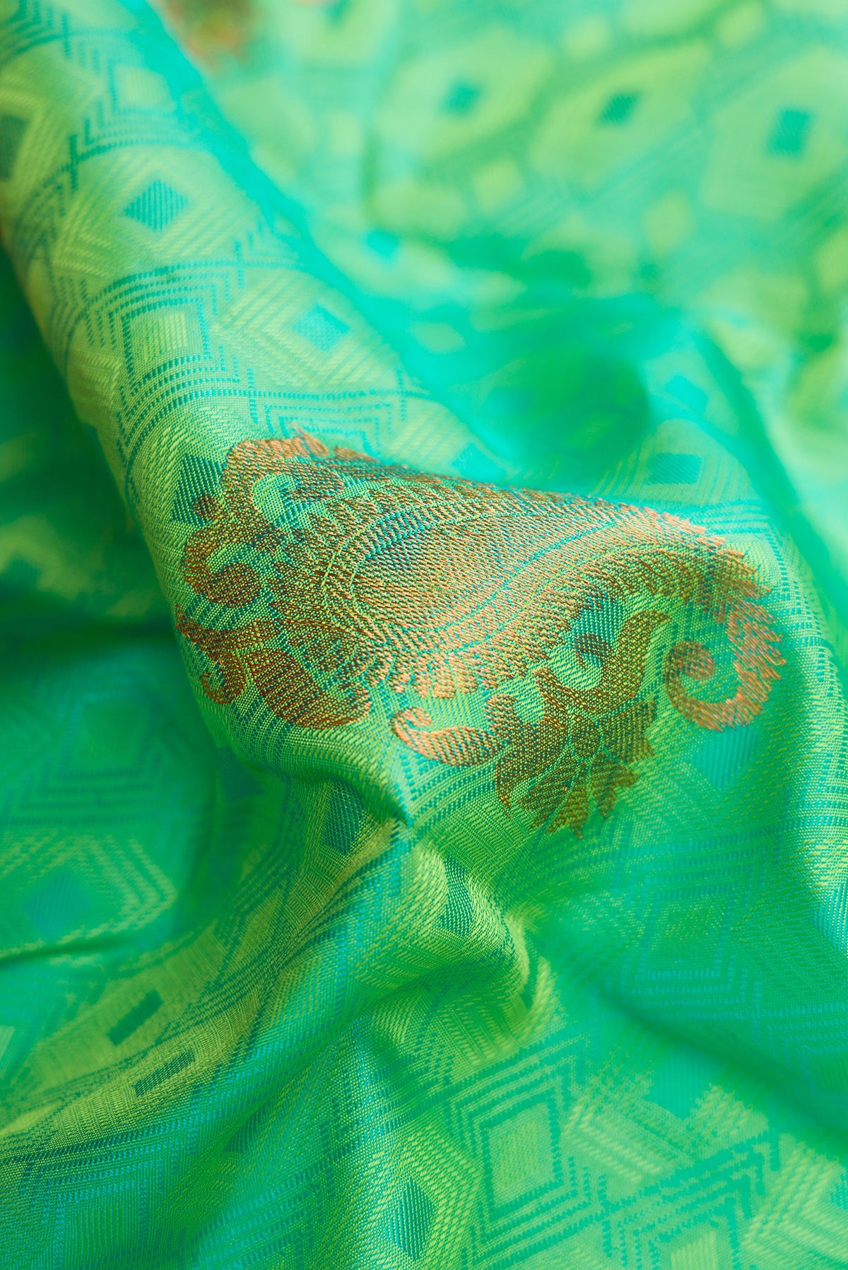 Close up of Sea Green Dual Tone Kanchipuram Silk Saree with Jacquard With Zari Butta on the body and Zari Border.  displaying folds