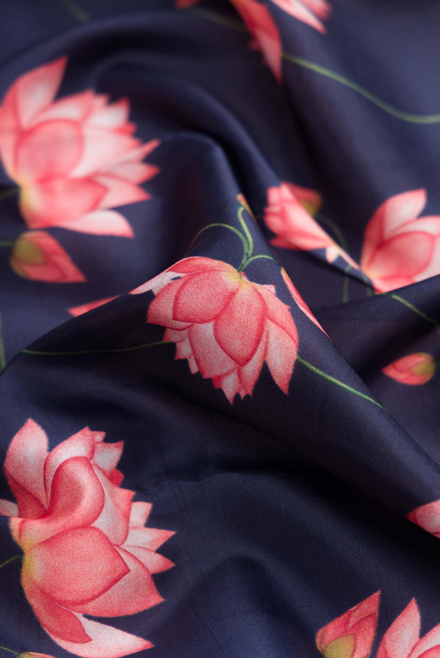 Close up of Navy Blue Dual Tone Kanchipuram Silk Saree with Printed design on the body and Zari Border.  displaying folds