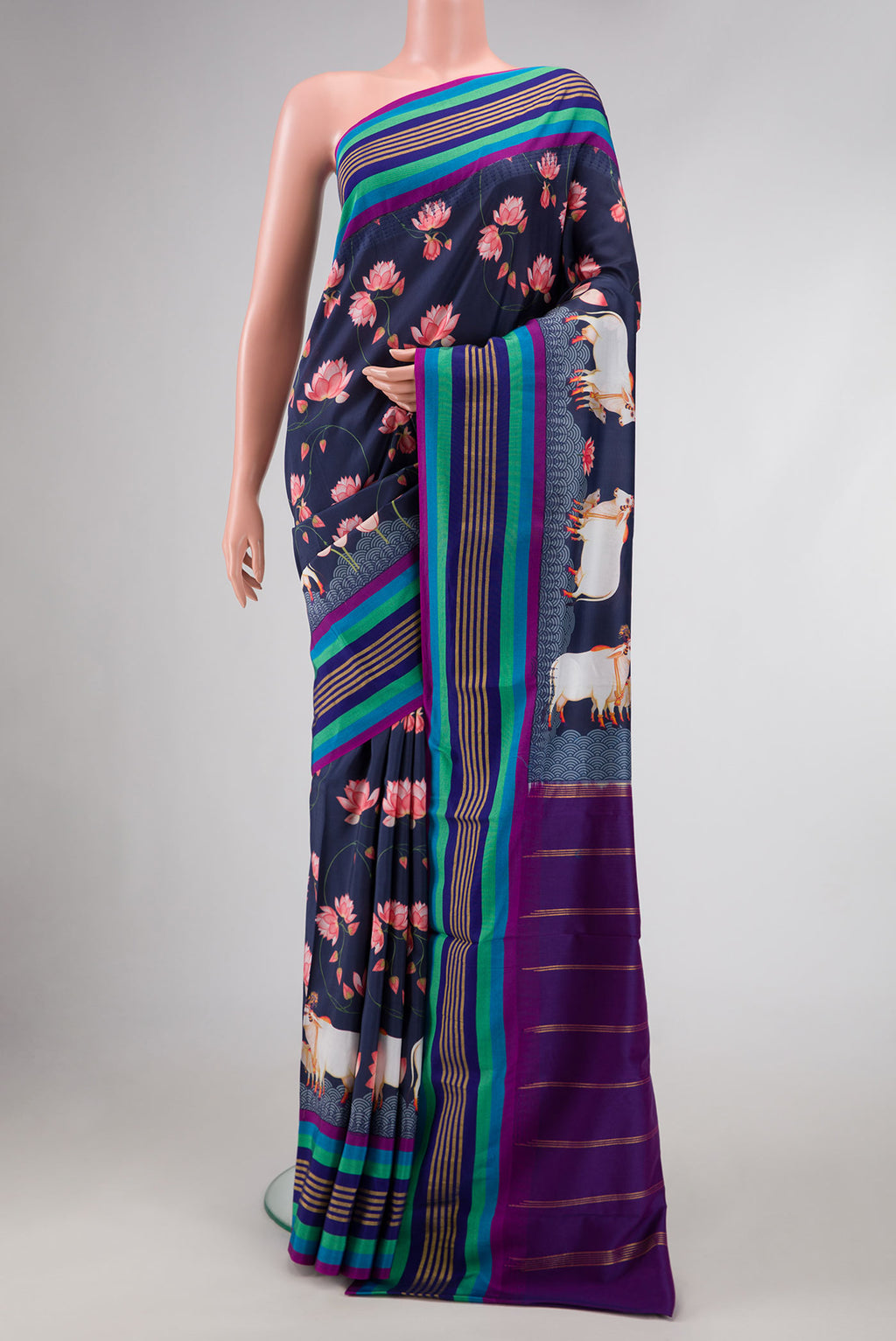 Navy Blue Dual Tone Kanchipuram Silk Saree with Printed design on the body and Zari Border.  displayed on a mannequin