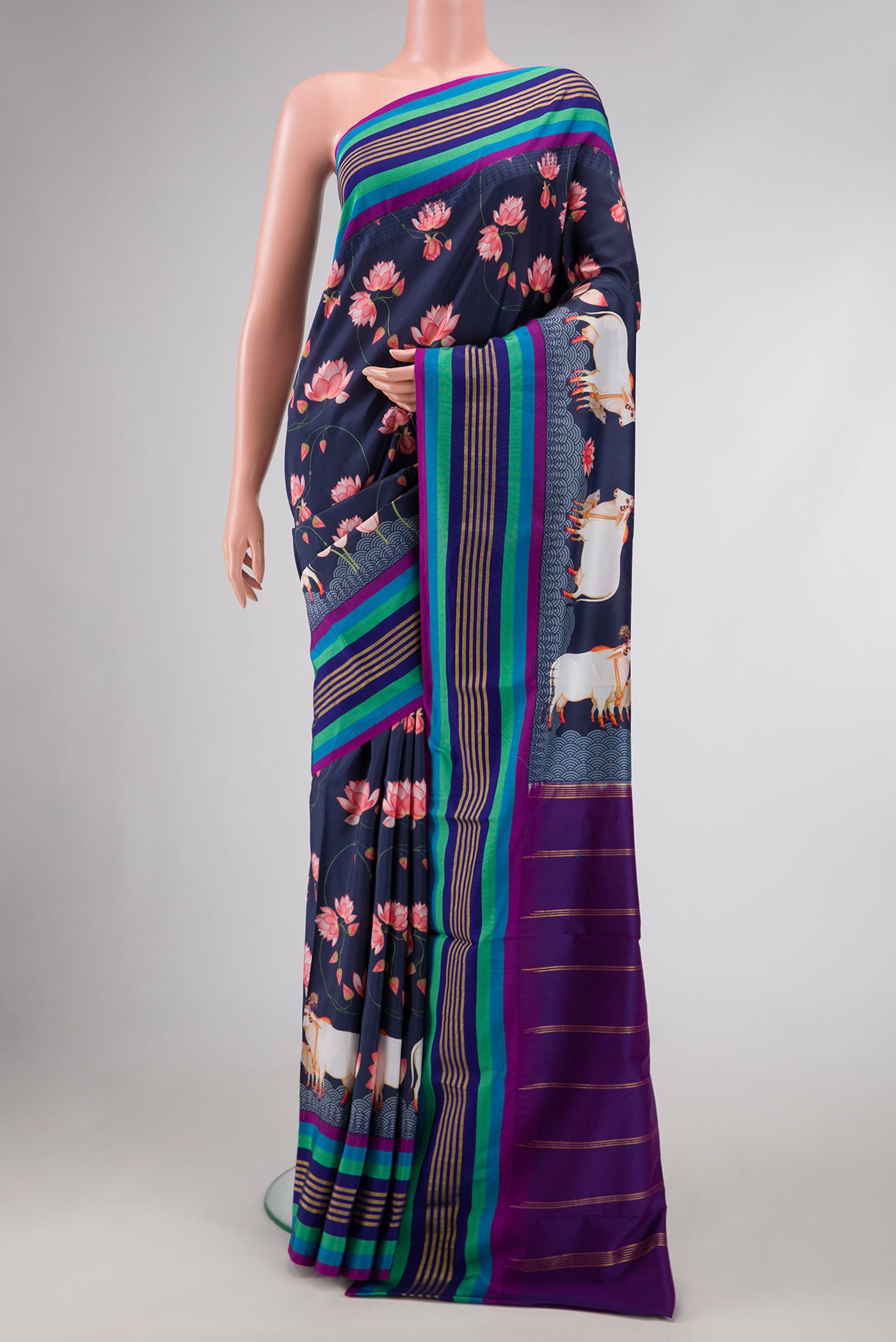 Navy Blue Dual Tone Kanchipuram Silk Saree with Printed design on the body and Zari Border.  displayed on a mannequin
