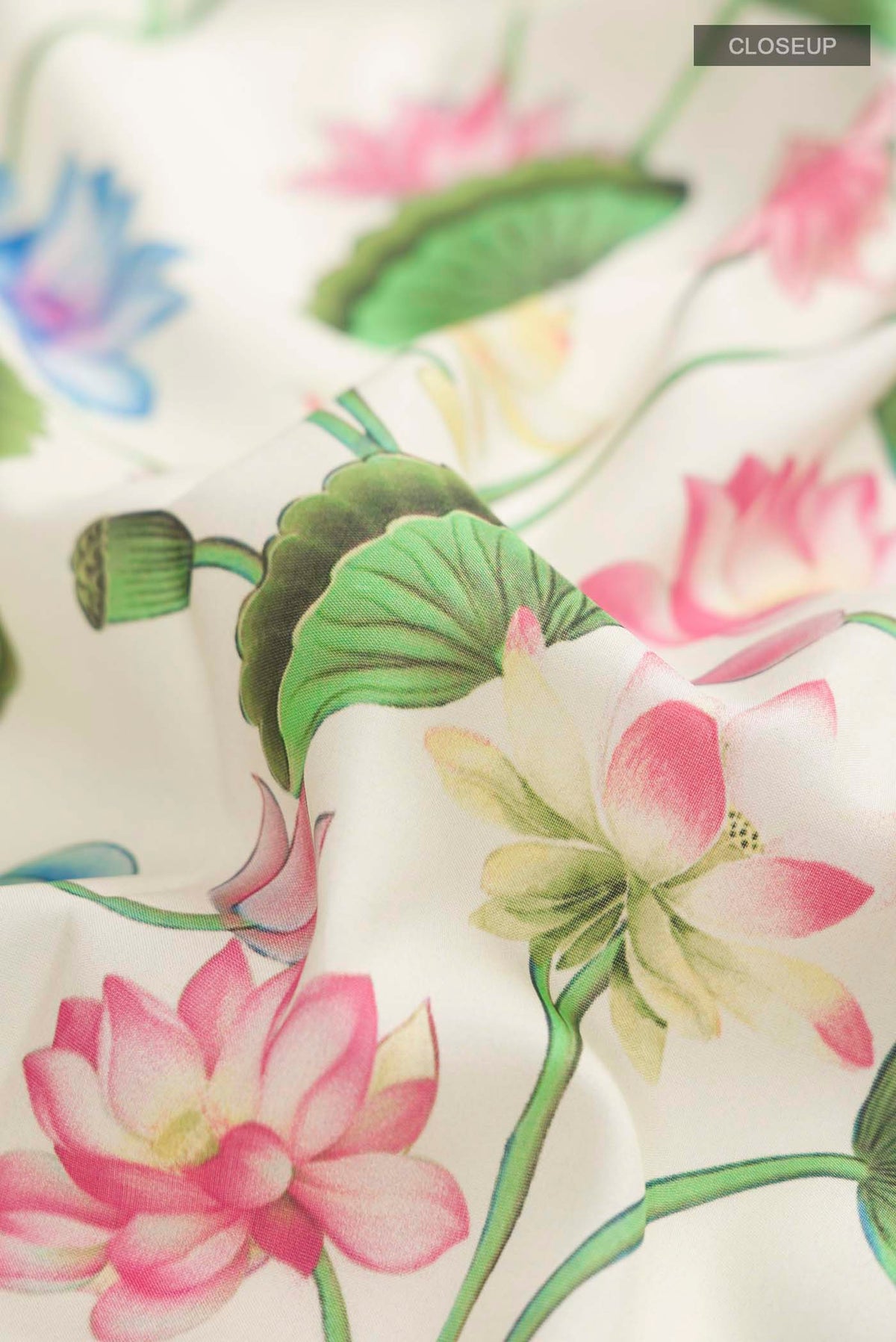 Close up of Cream Printed Silk Saree with Printed design on the body and Zari Border displaying folds