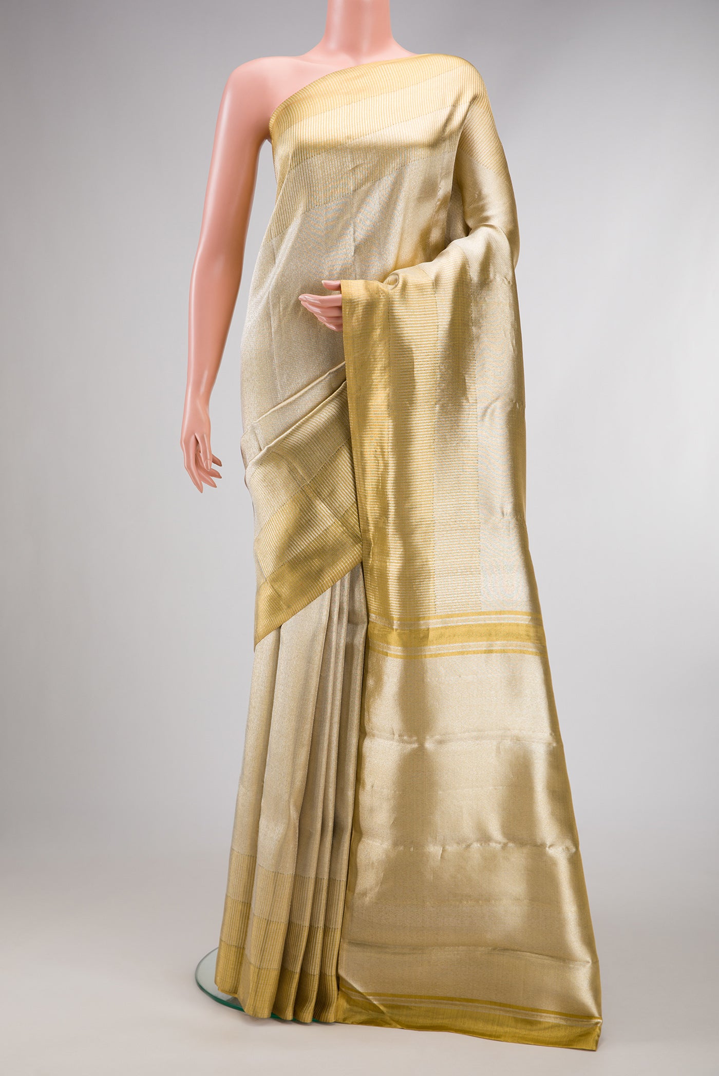 Gold Dual Tone Kanjivaram Tissue Silk Saree with Zari Brocade on the body and Zari Border.  displayed on a mannequin