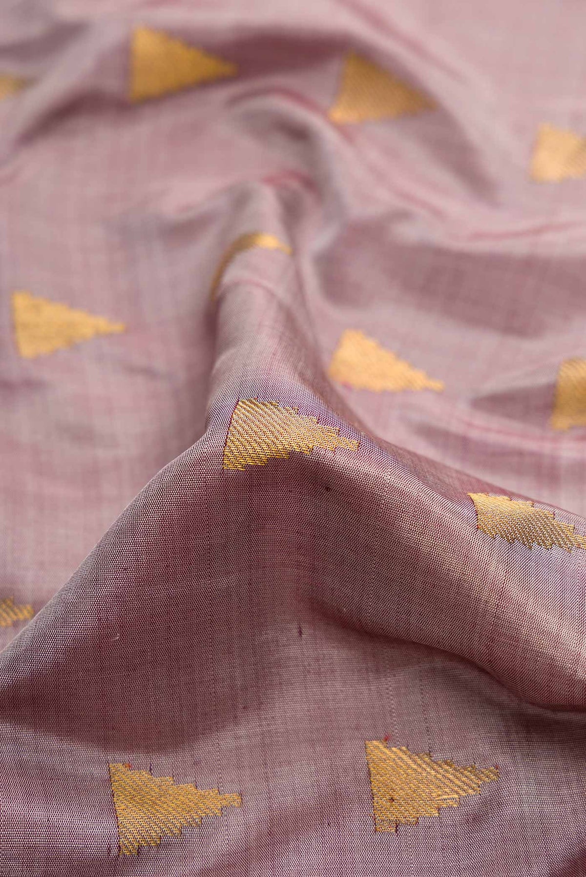 Close up of Lavender Gadwal Silk Saree with Zari Butta on the body and Temple Border displaying folds