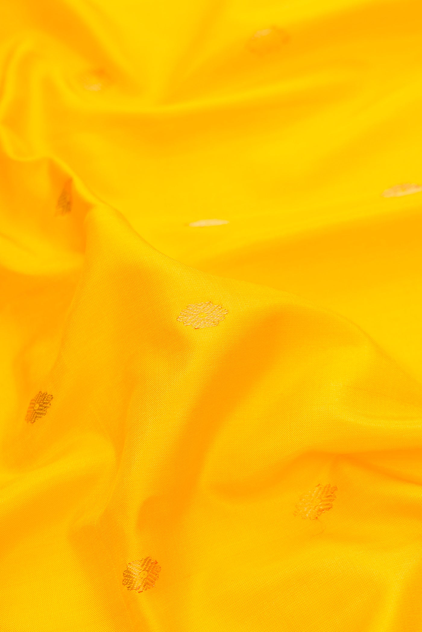 Close up of Yellow Dual Tone Gadwal Silk Saree with Zari Butta on the body and Zari Border.  displaying folds
