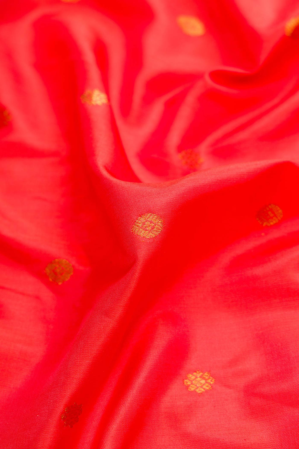 Close up of Brick Orange Dual Tone Gadwal Silk Saree with Zari Butta on the body and Zari Border displaying folds