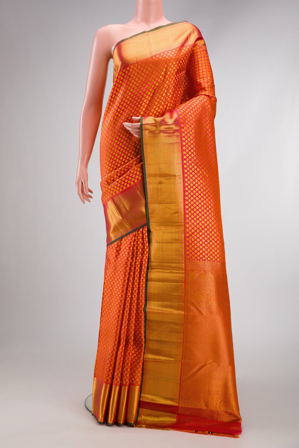 Orange Kanjivaram Silk Saree with Zari Brocade on the body and Zari Border.  displayed on a mannequin