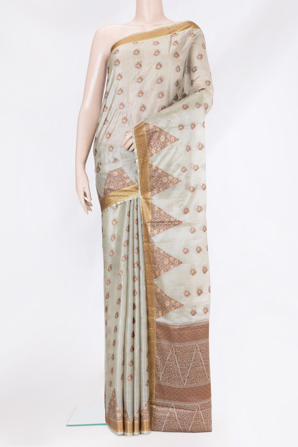 Beige Tussar Silk Saree with Thread Butta on the body and Fancy Border.  displayed on a mannequin