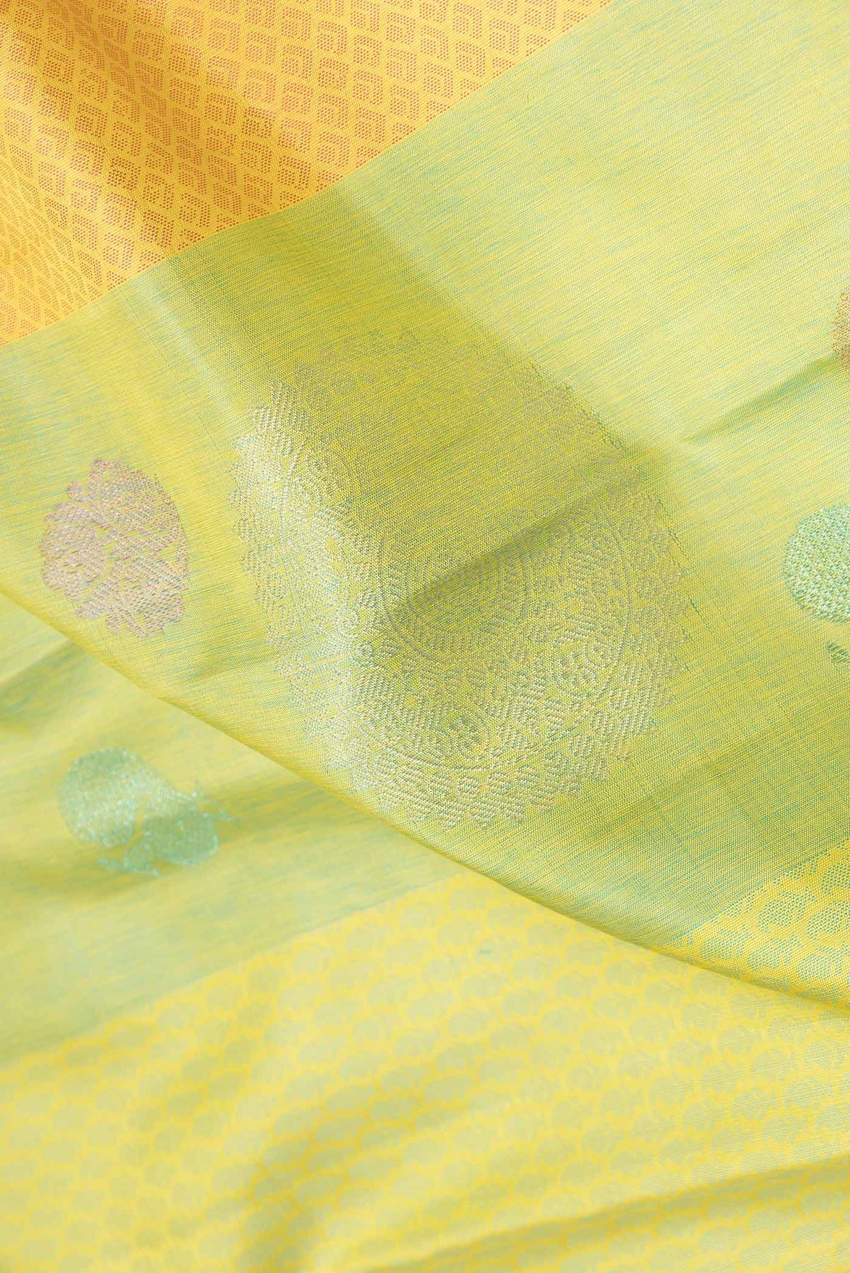 Close up of Pista Green Dual Tone Kanchipuram Silk Saree with Jacquard With Zari Butta on the body and Without Border displaying folds