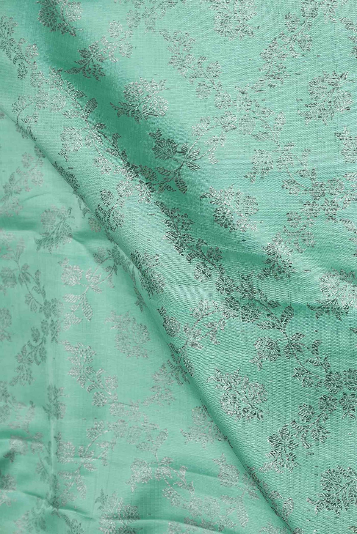 Close up of Sea Green Dual Tone Kanchipuram Silk Saree with Zari Brocade on the body and Zari Border displaying folds