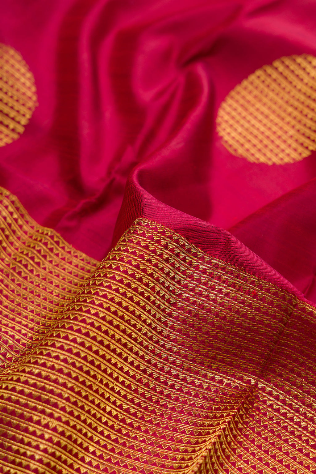 Close up of Maroon Kanchipuram Silk Saree with Half And Half on the body and Without Border.  displaying folds