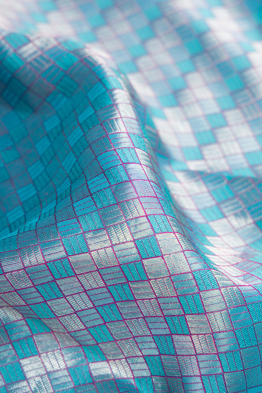 Close up of Sky Blue Dual Tone Kanchipuram Silk Saree with Zari Brocade on the body and Zari Border.  displaying folds