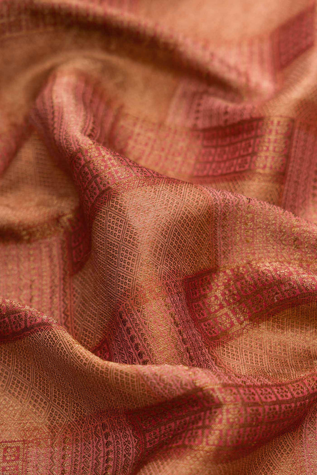 Close up of Maroon Dual Tone Banarasi Georgette Saree with Zari Brocade on the body and Zari Border.  displaying folds