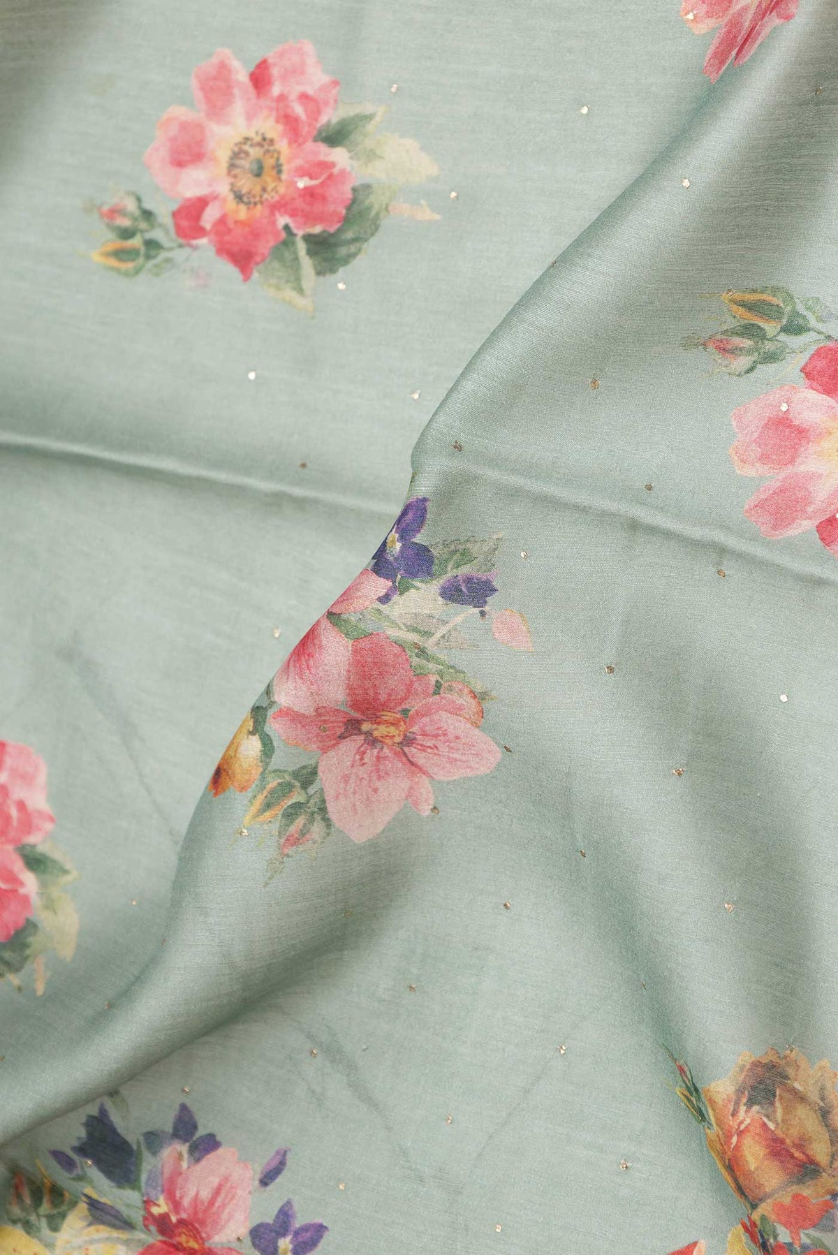 Close up of Green Dual Tone Chanderi Silk Saree with Printed design on the body and Zari And Thread Border displaying folds