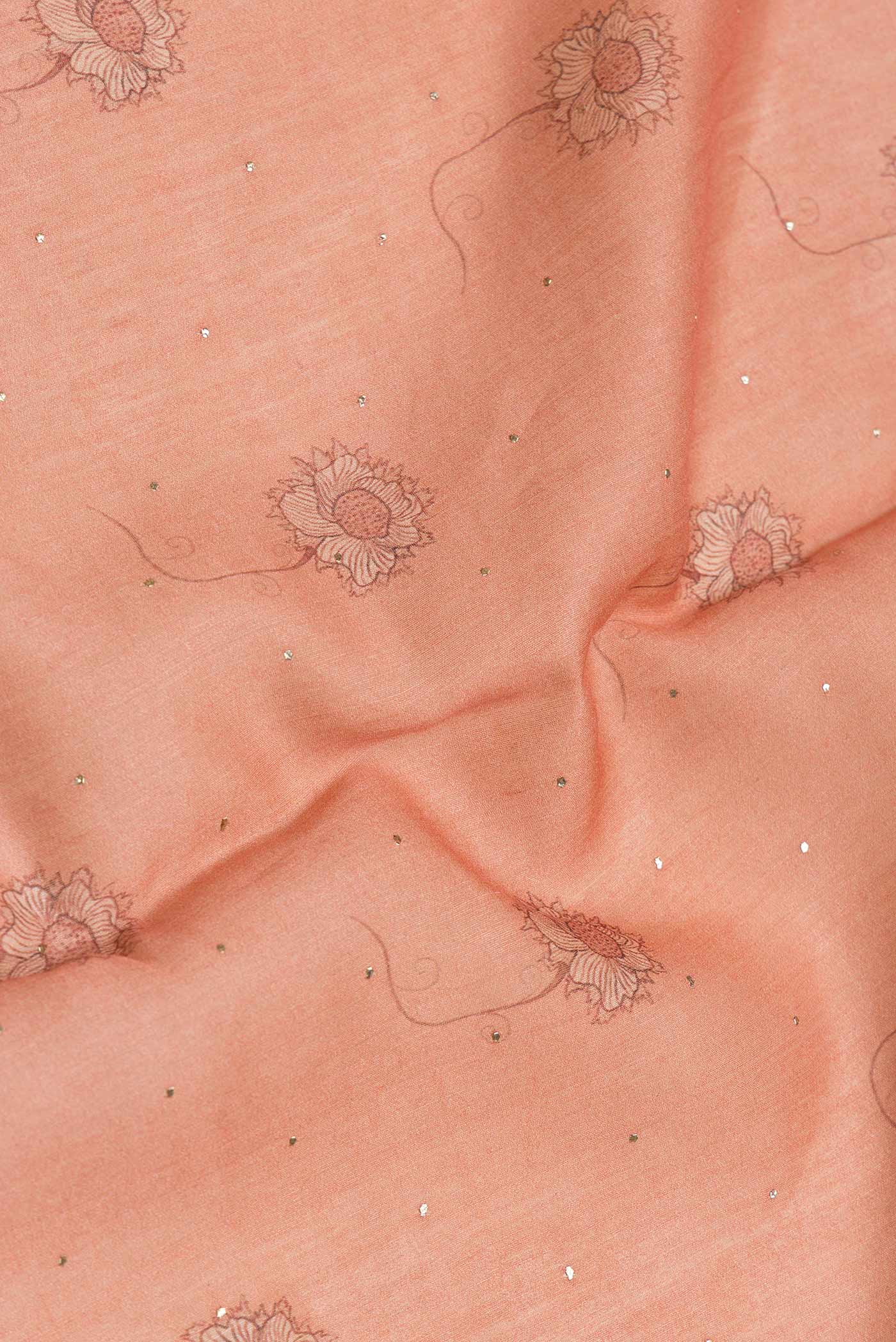 Close up of Peach Dual Tone Tussar Silk Saree with Printed design on the body and Zari Border.  displaying folds