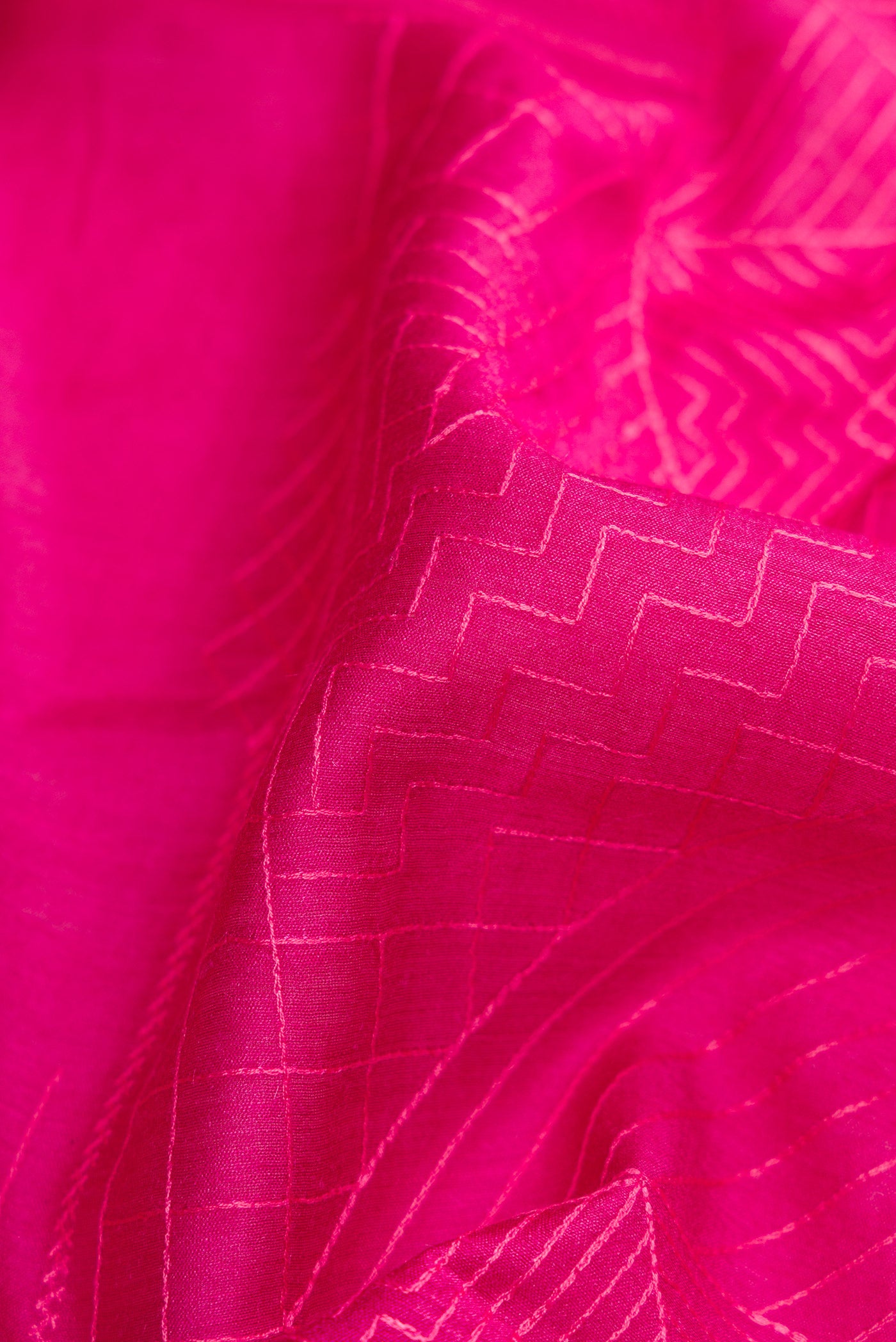 Close up of Pink Dual Tone Tussar Silk Saree with Embroidery on the body and Fancy Border.  displaying folds