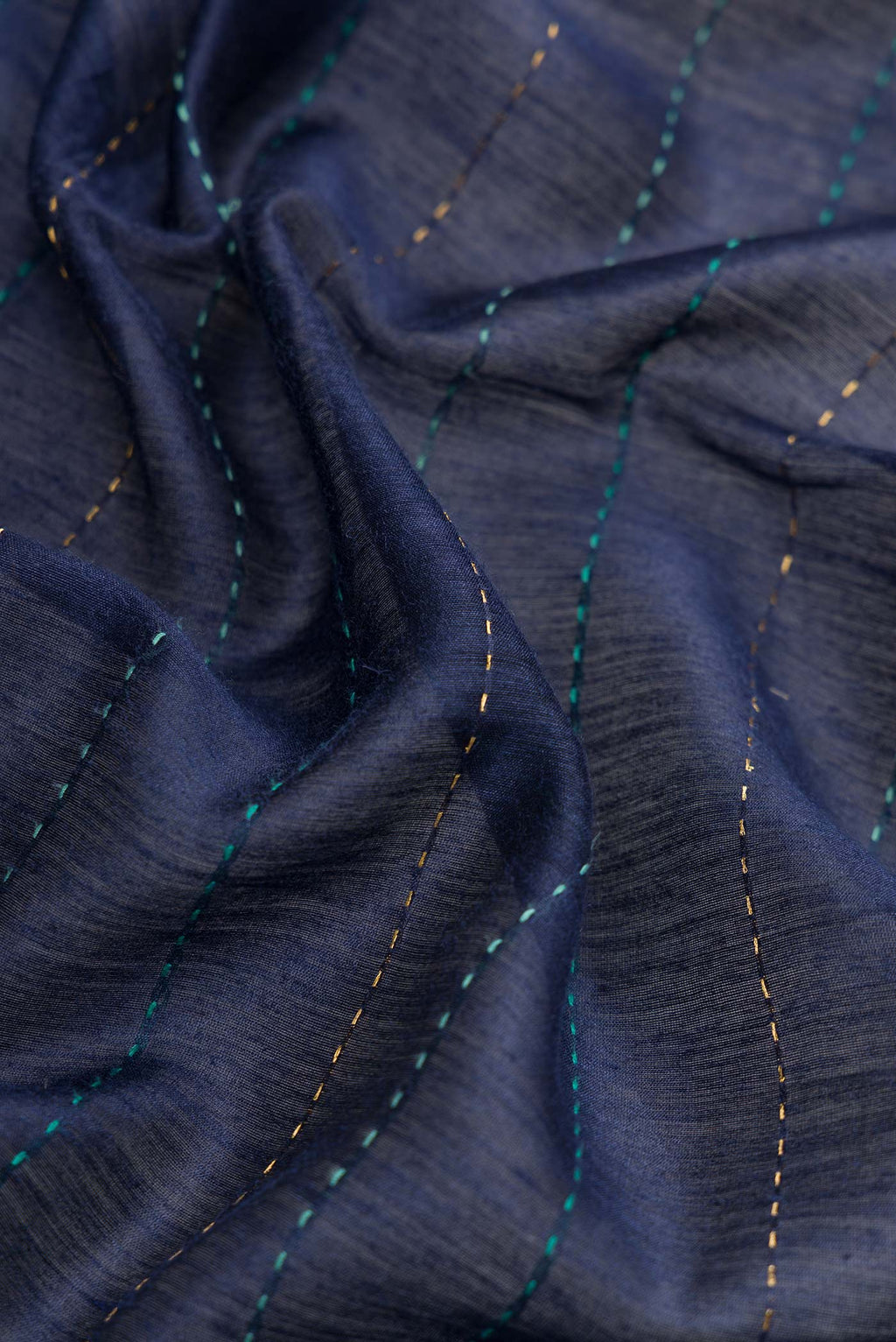 Close up of Navy Blue Dual Tone Tussar Silk Saree with Printed design on the body and Zari Border.  displaying folds