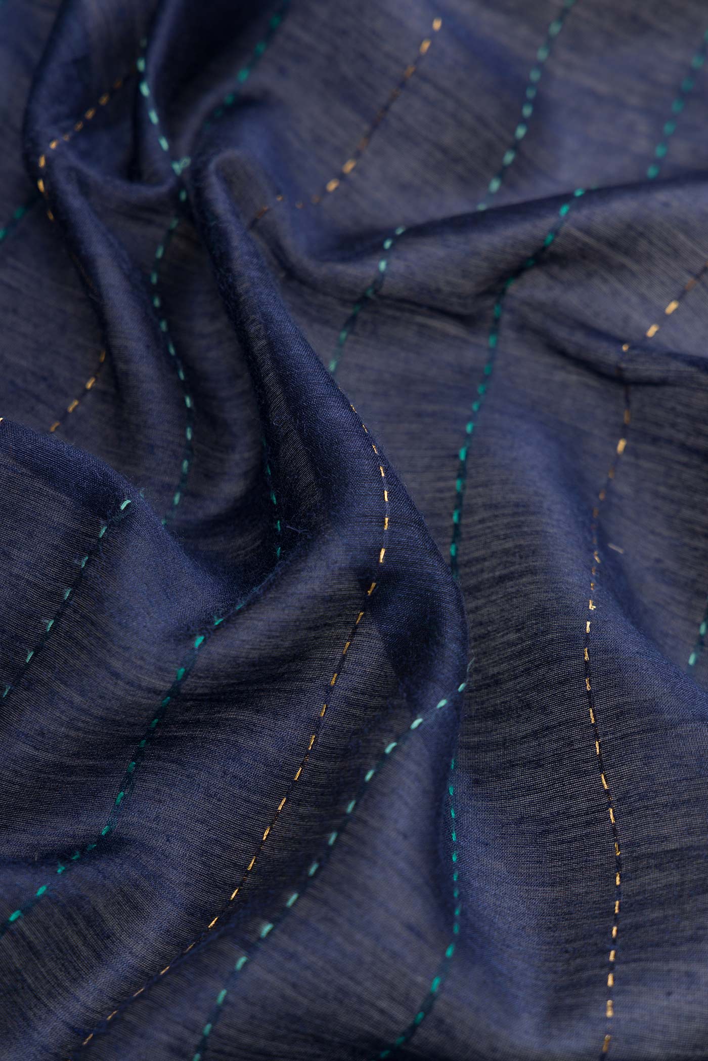 Close up of Navy Blue Dual Tone Tussar Silk Saree with Printed design on the body and Zari Border.  displaying folds