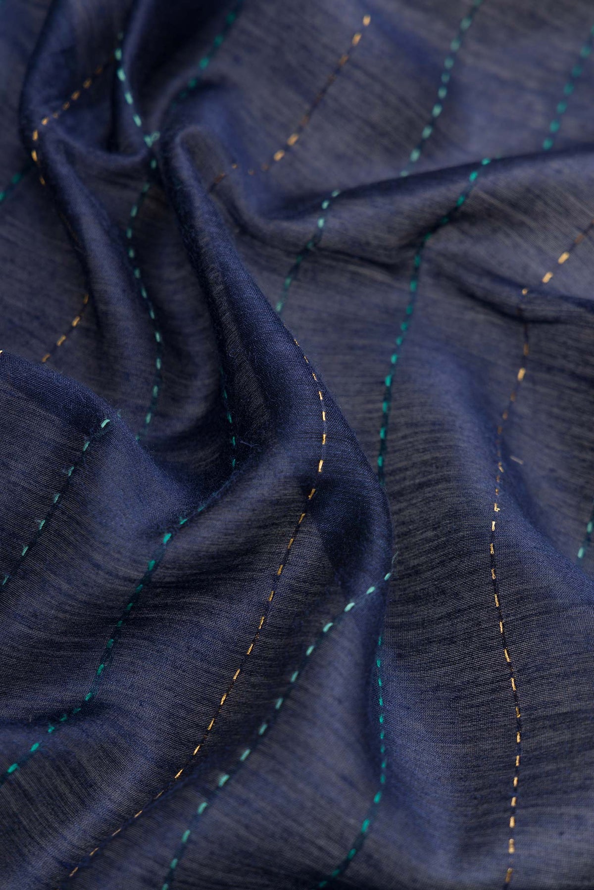Close up of Navy Blue Dual Tone Tussar Silk Saree with Printed design on the body and Zari Border.  displaying folds