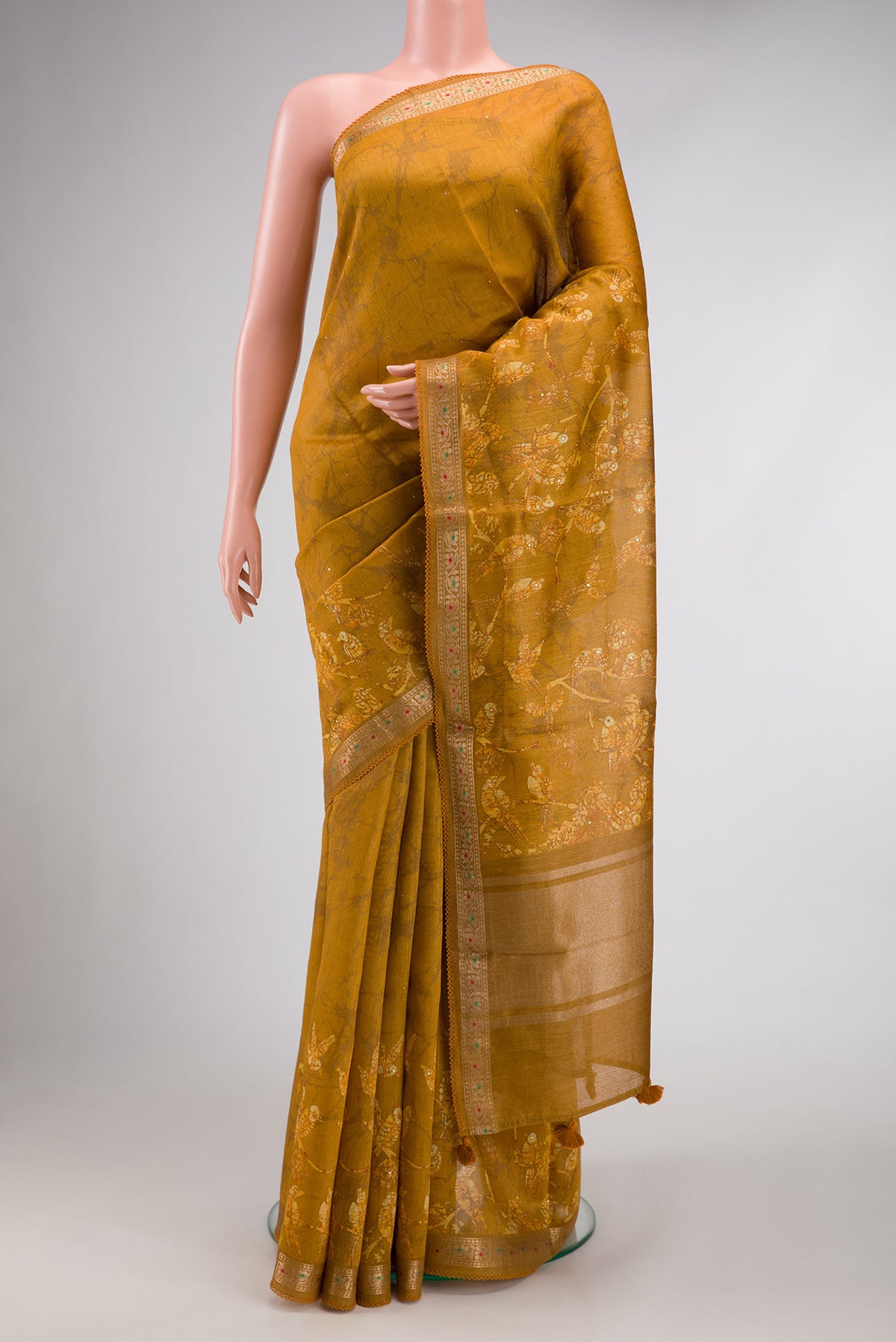Mustard Dual Tone Tussar Silk Saree with Printed design on the body and Zari Border.  displayed on a mannequin