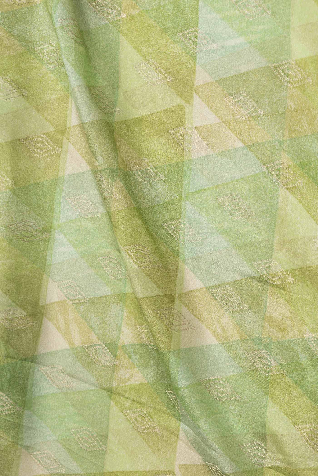 Close up of Green Dual Tone Mysore Crepe Saree with Printed design on the body and Zari Border displaying folds