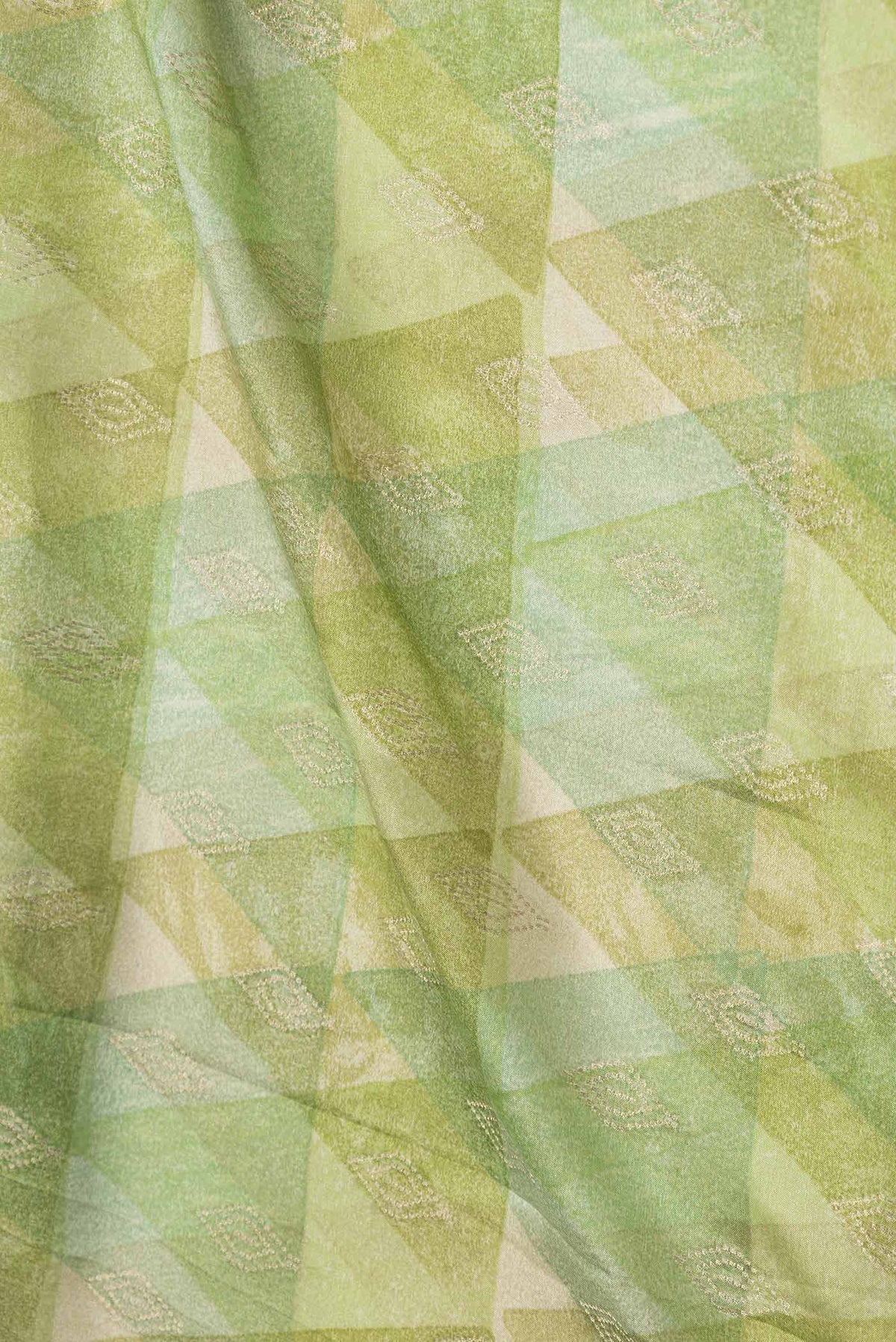 Close up of Green Dual Tone Mysore Crepe Saree with Printed design on the body and Zari Border displaying folds
