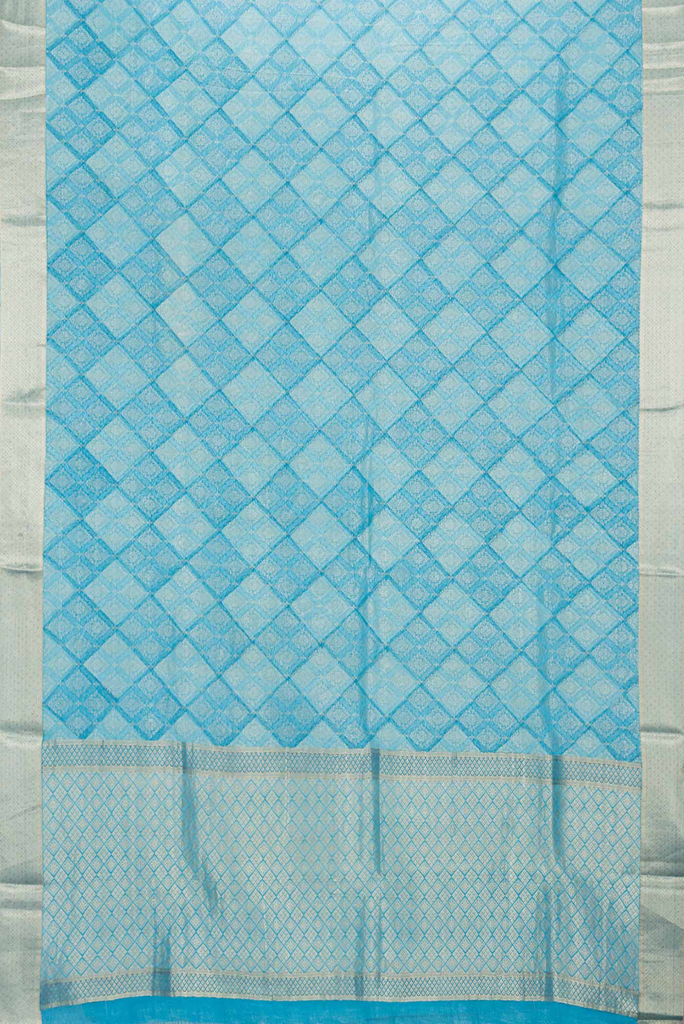 Flat view of Sky Blue Dual Tone Banarasi Silk Saree with Zari Butta on the body and Zari Border. 