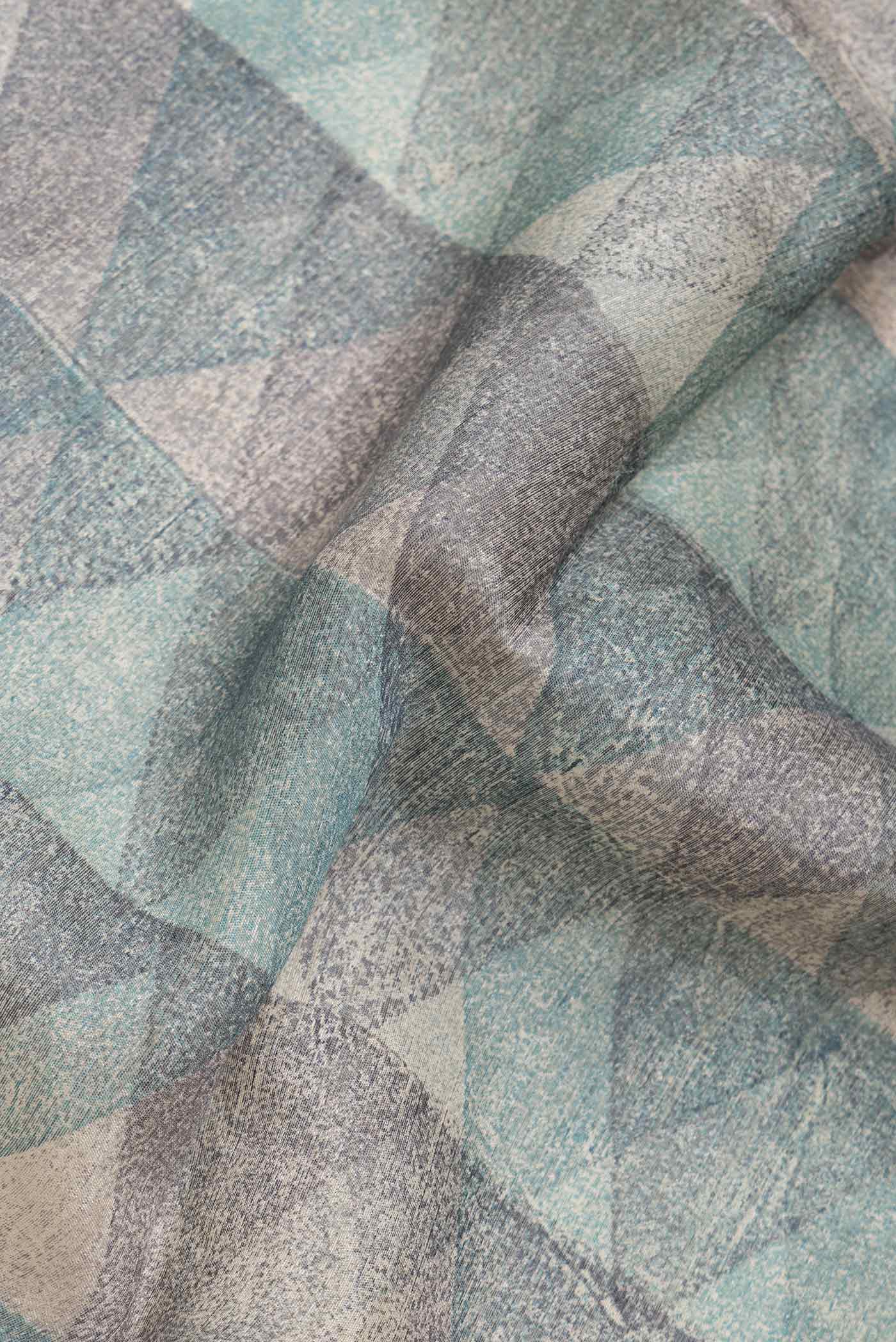 Close up of Blue and Grey Color Tussar Silk Saree with Printed design on the body and Zari Border.  displaying folds