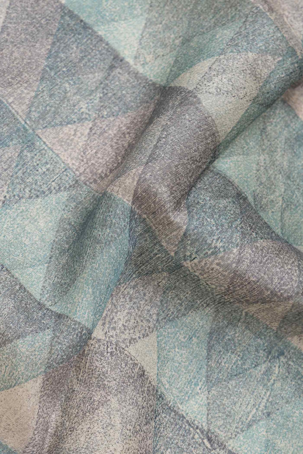 Close up of Blue and Grey Color Tussar Silk Saree with Printed design on the body and Zari Border.  displaying folds