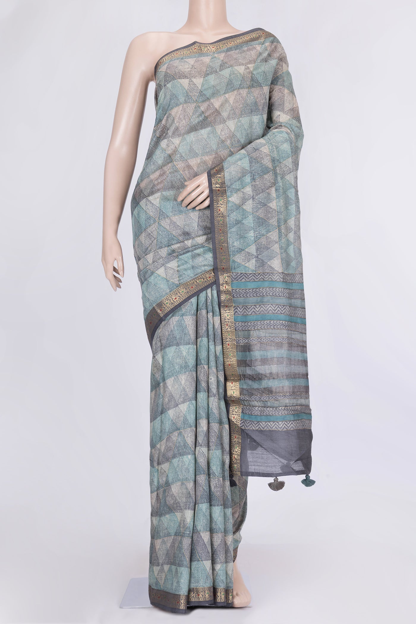 Blue and Grey Color Tussar Silk Saree with Printed design on the body and Zari Border.  displayed on a mannequin