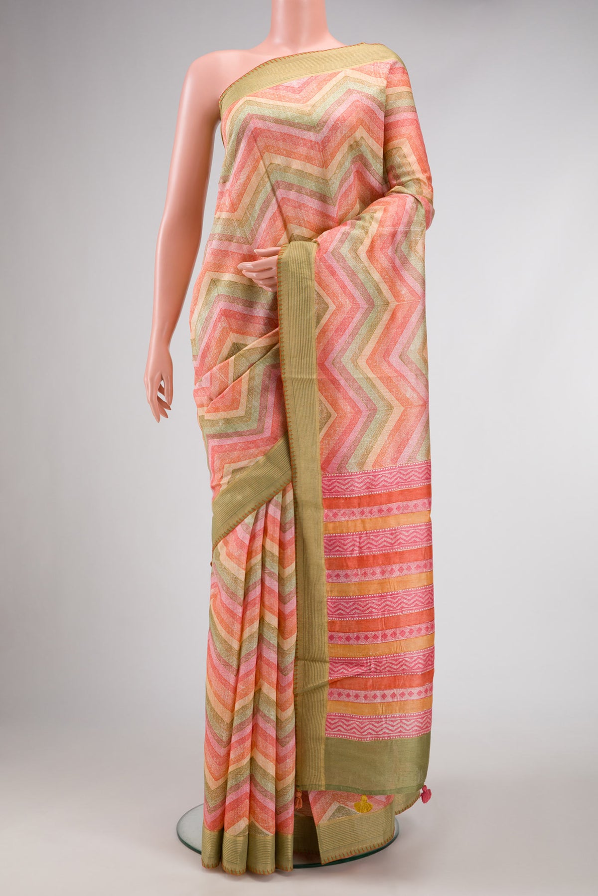 Peach Dual Tone Tussar Silk Saree with Printed design on the body and Zari Border.  displayed on a mannequin