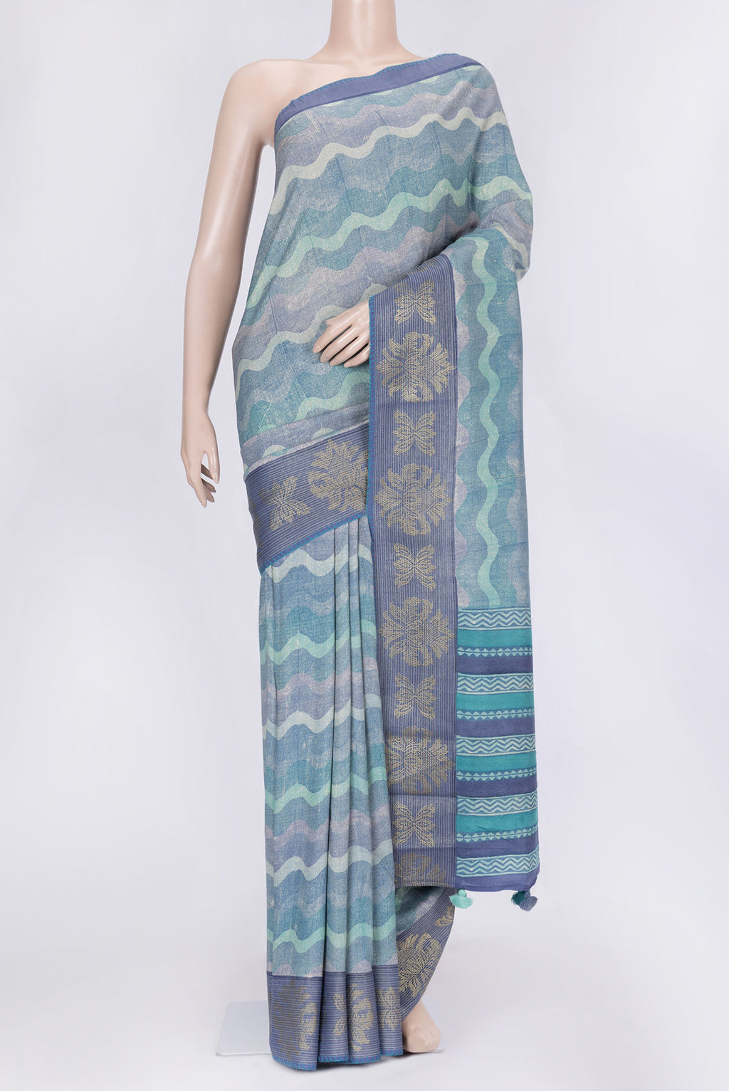 Blue and Grey Color Tussar Silk Saree with Printed design on the body and Zari Border.  displayed on a mannequin
