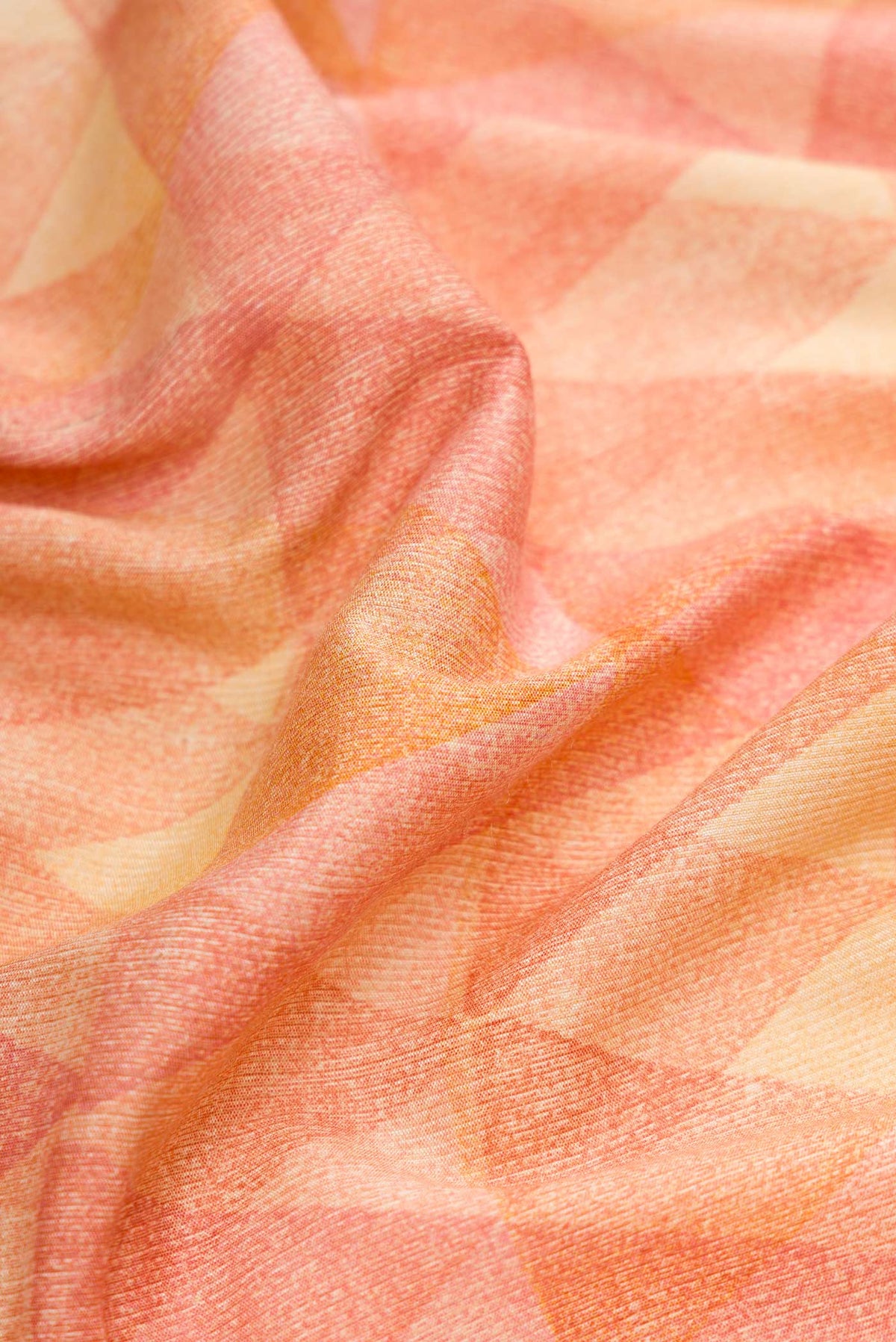 Close up of Peach Dual Tone Tussar Silk Saree with Printed design on the body and Zari Border.  displaying folds