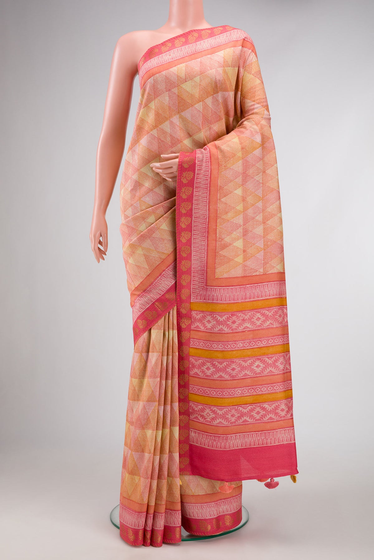 Peach Dual Tone Tussar Silk Saree with Printed design on the body and Zari Border.  displayed on a mannequin