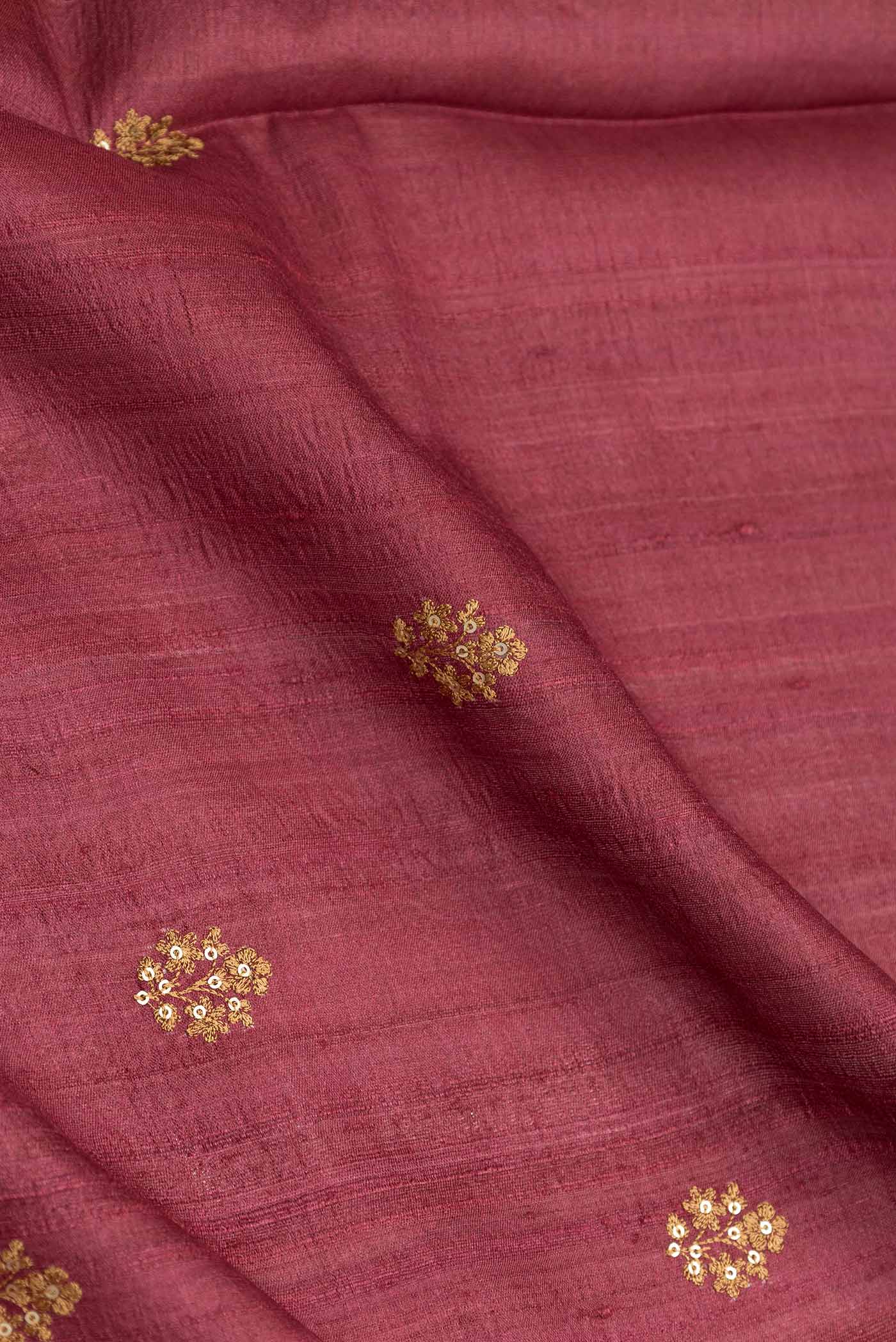 Close up of Maroon Dual Tone Tussar Silk Saree with Embroidery on the body and Printed Border displaying folds